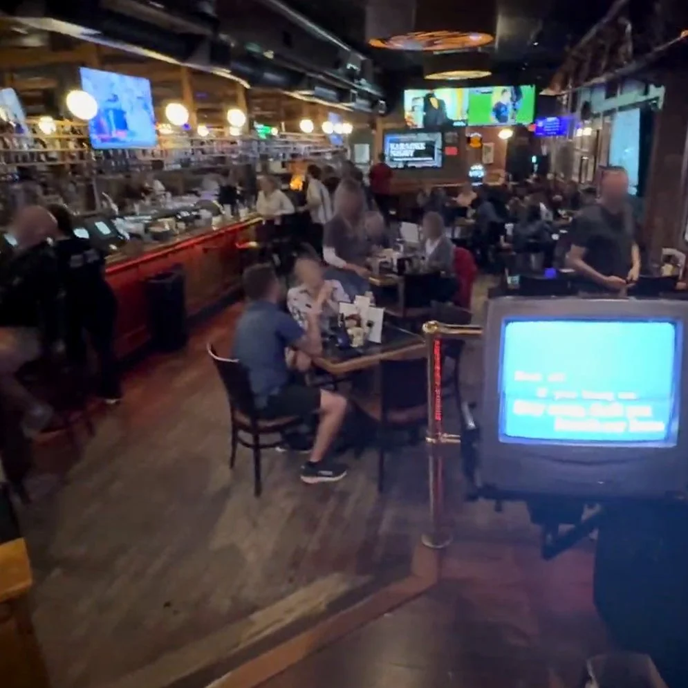View from the karaoke stage at Z’s Bar & Restaurant in downtown Grand Rapids, Michigan, showing the crowd, bar and singer lyric screen during the GRkaraoke.com Karaoke Marathon 2026