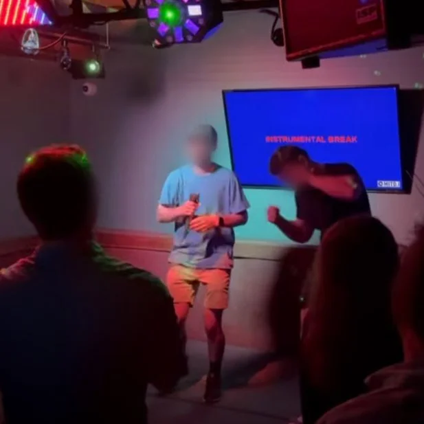 Two singers performing karaoke together at The B.O.B. in downtown Grand Rapids, Michigan, with the lyric screen and crowd during the GRkaraoke.com Karaoke Marathon 2026