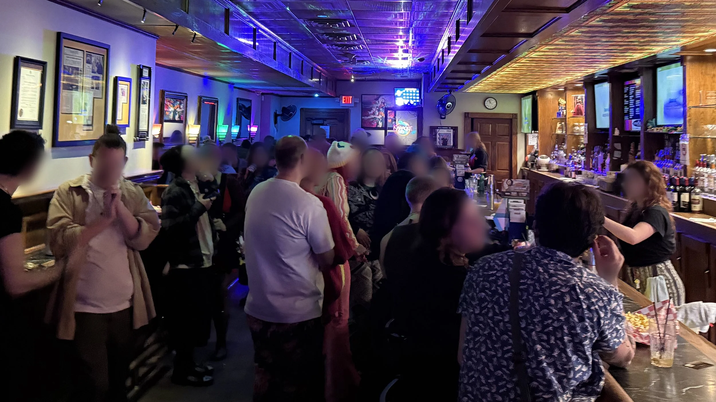 Inside The Apartment Lounge in downtown Grand Rapids, Michigan, showing the crowd, bar and colorful lighting during a busy karaoke night for the GRkaraoke.com Karaoke Marathon 2026