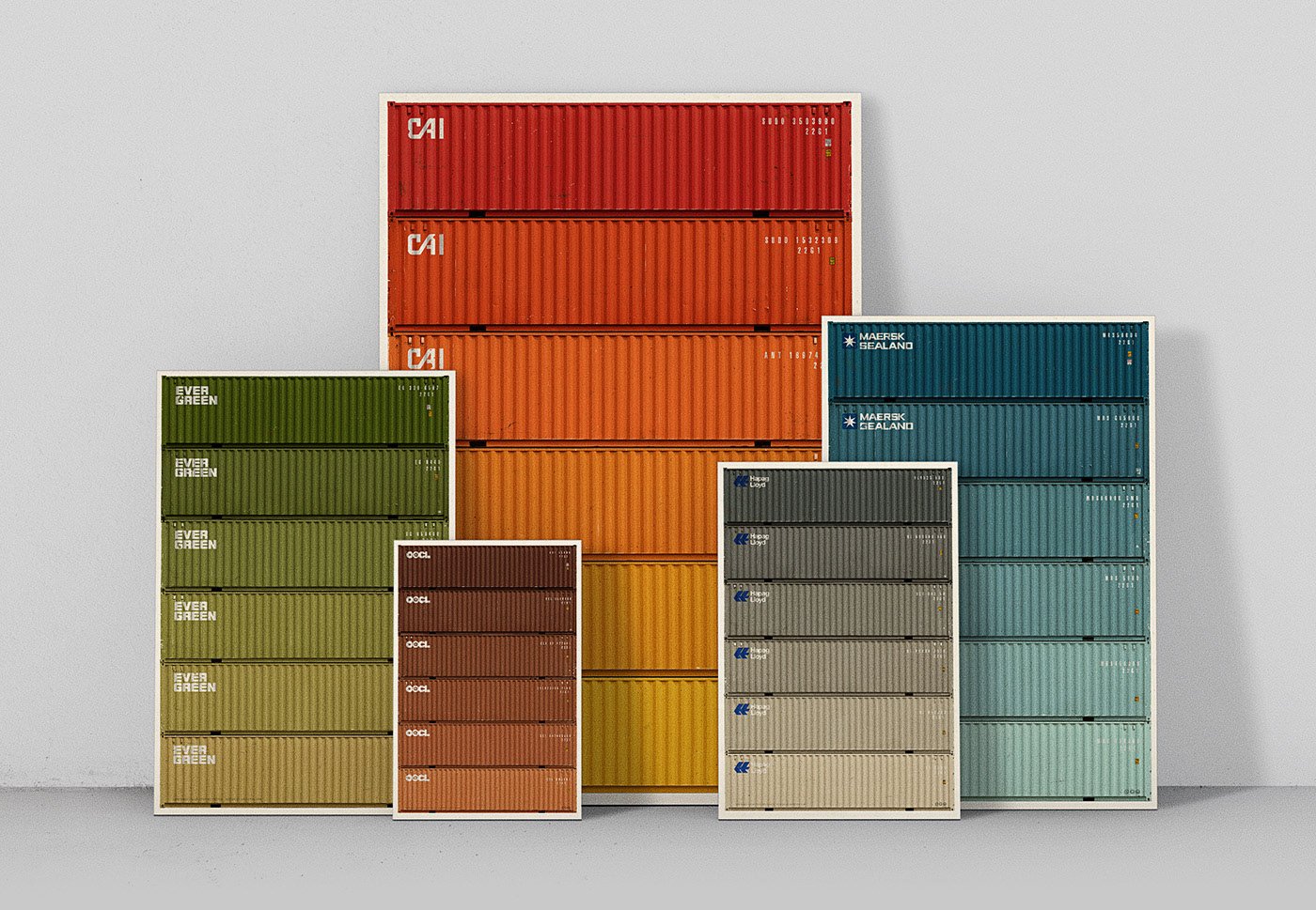 A collection of colorful shipping containers stacked against a plain wall.