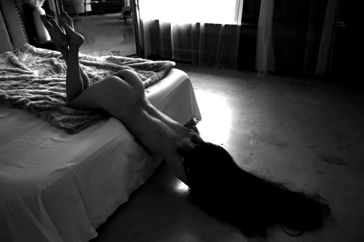 Bella Venus lying on a bed 