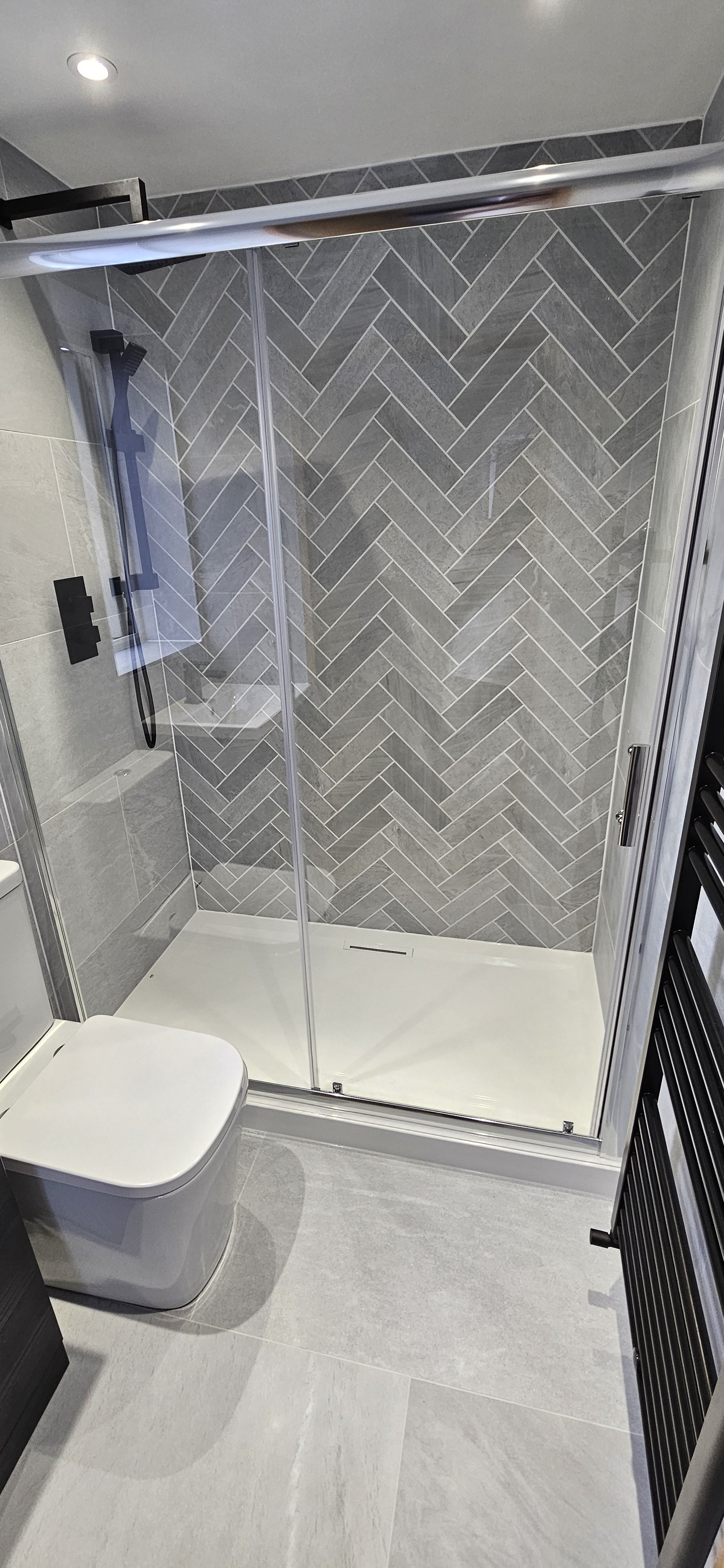 Herringbone style feature wall has a bold impact on this room