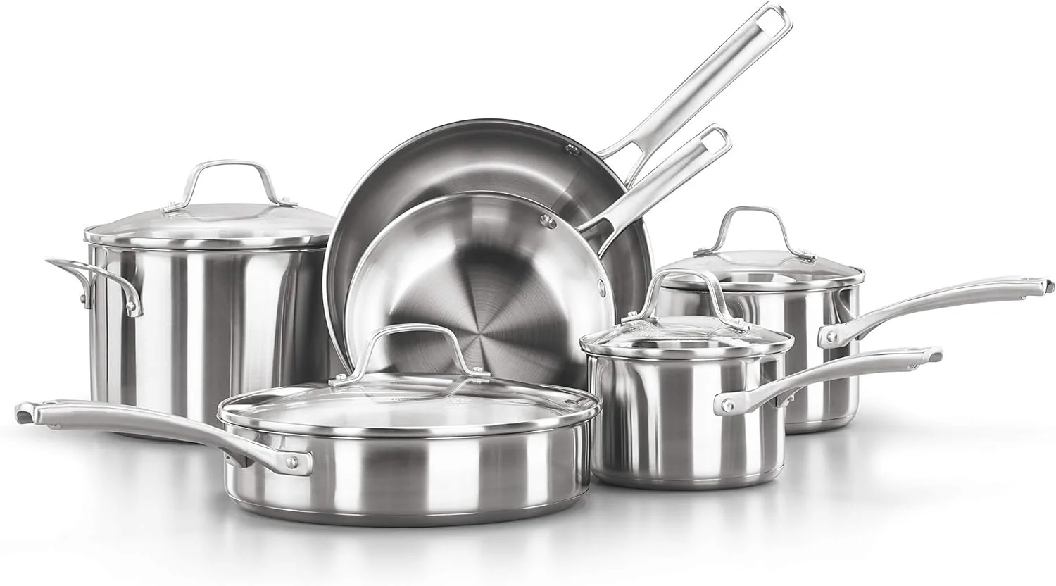 Set of stainless steel cookware including pots with glass lids and frying pans, arranged on a white background.
