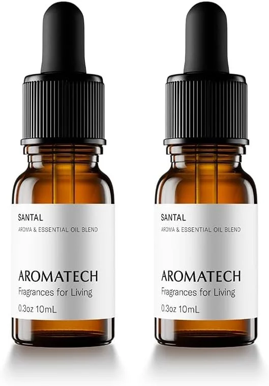 Two amber glass bottles with black dropper caps labeled 'Aromatech Santal Aroma & Essential Oil Blend Fragrances for Living'