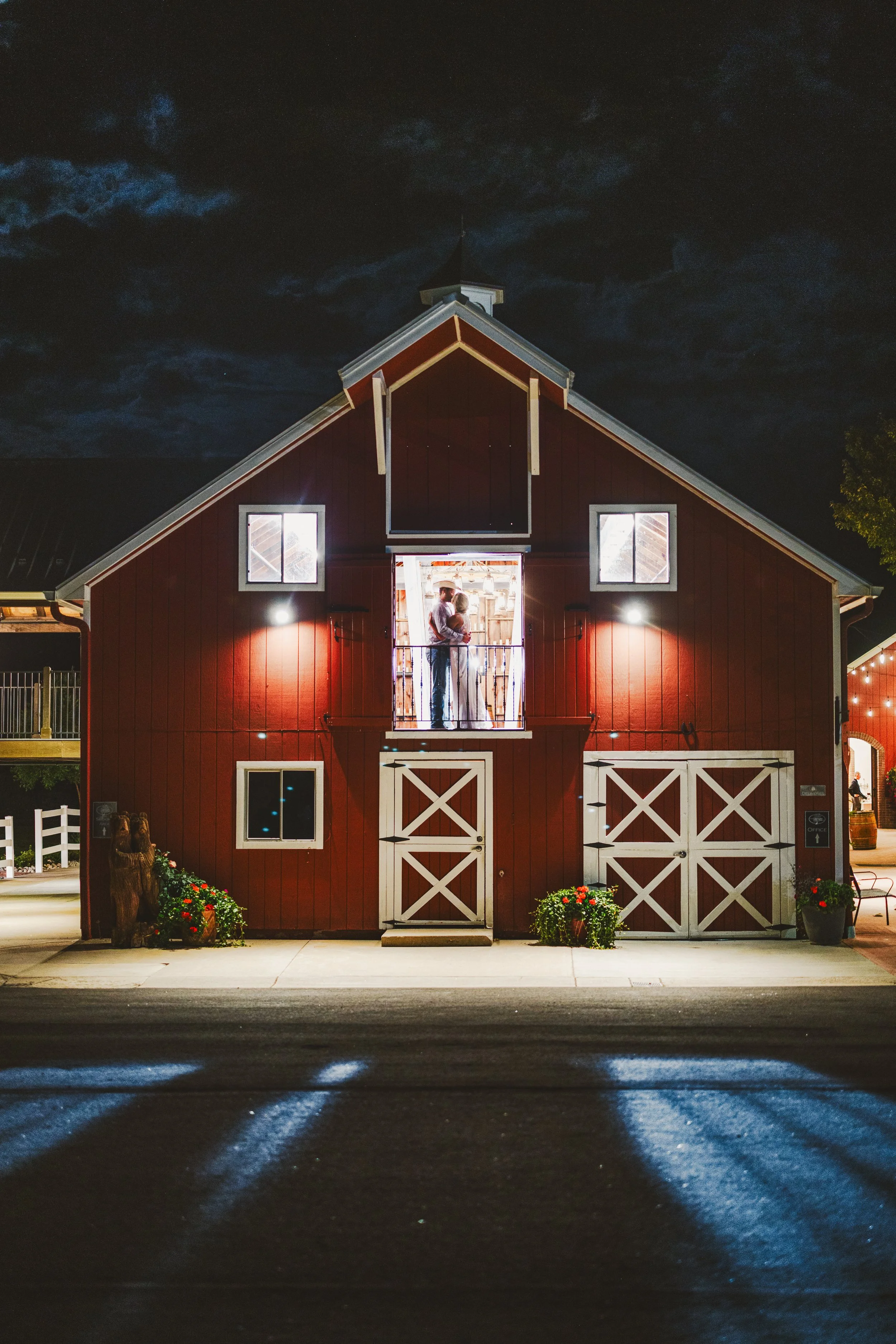 couple in a barn illuminated by a flash