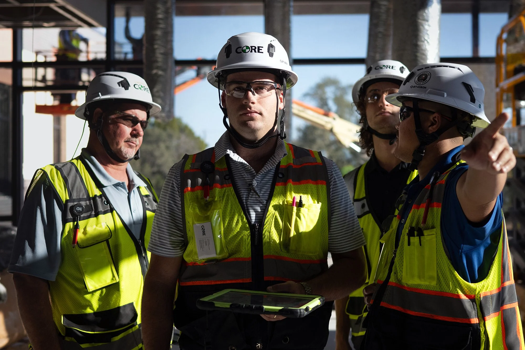 View the CORE Construction portfolio: a field team reviews work together on an active construction site.