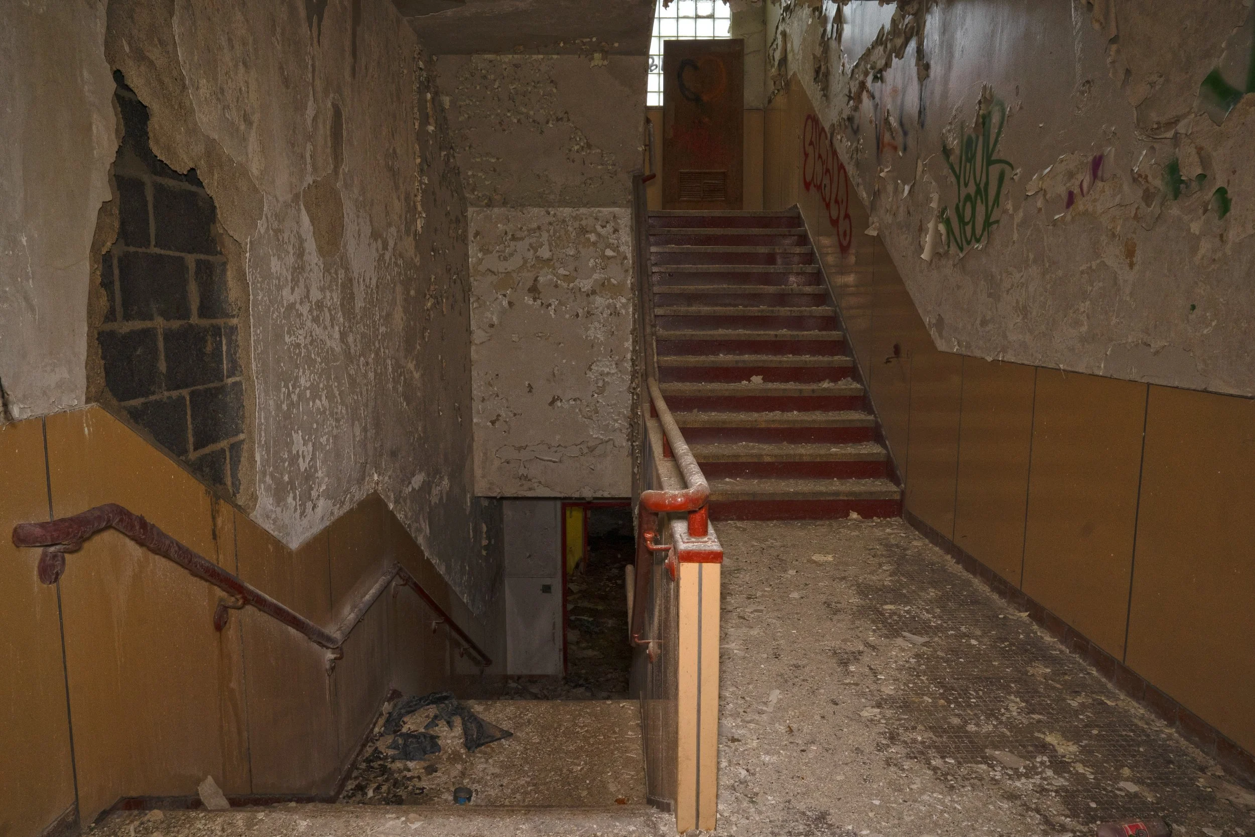 Staircase at the end of the hallway on the 2nd floor opposite of the Gymnasium that leads to the 1st floor and 3rd floor above 
