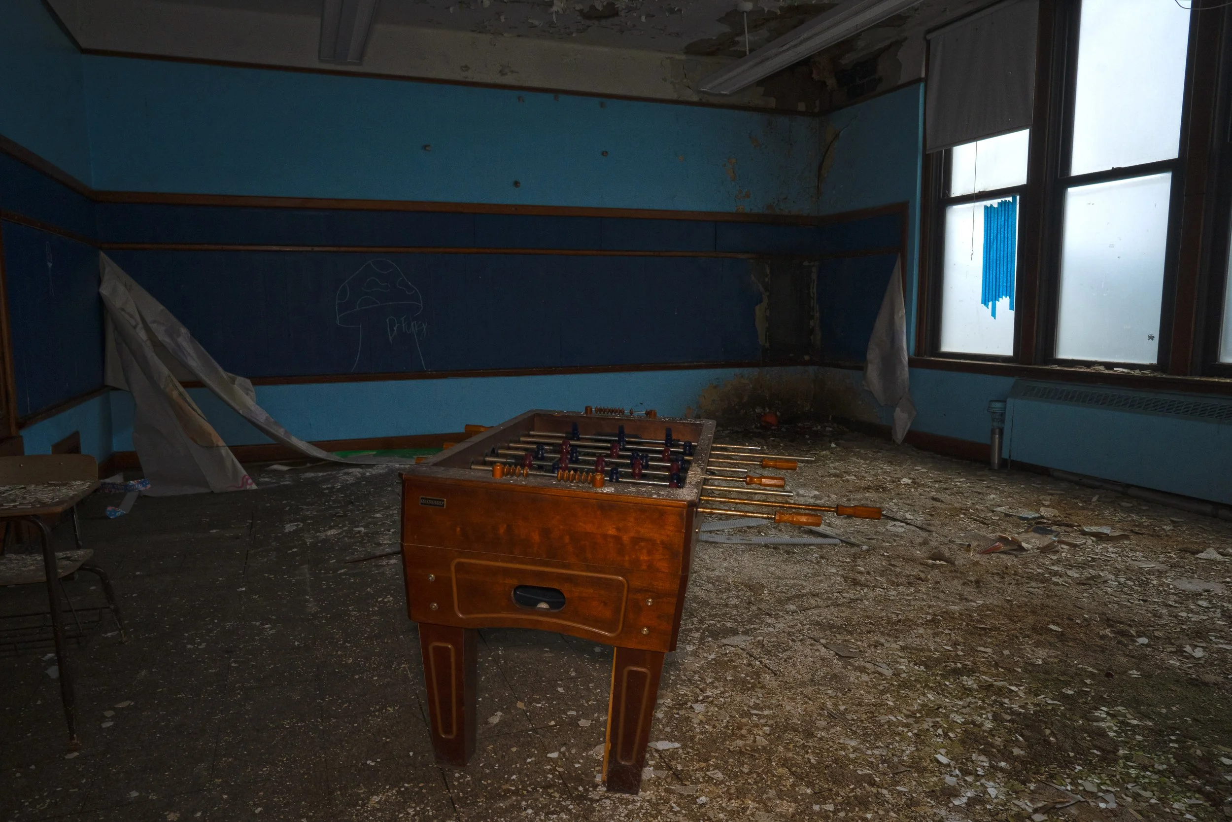 A 2nd floor room with a Foosball table and air hockey table 