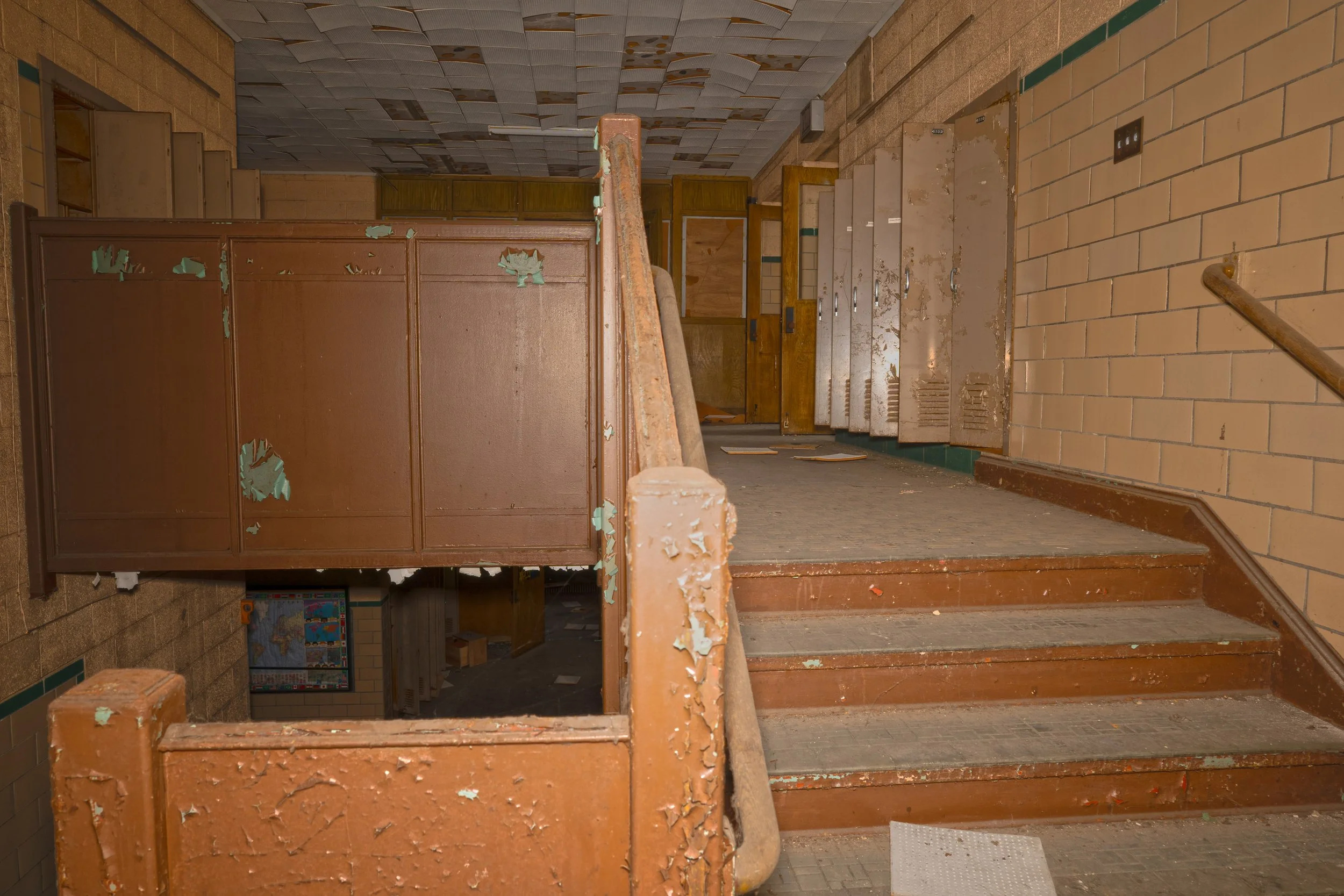 Eastern staircase below the intact display case of the world can be seen and above the 2nd floor behind the wood wall in the background of the 2nd floor is the locker room shown earlier 