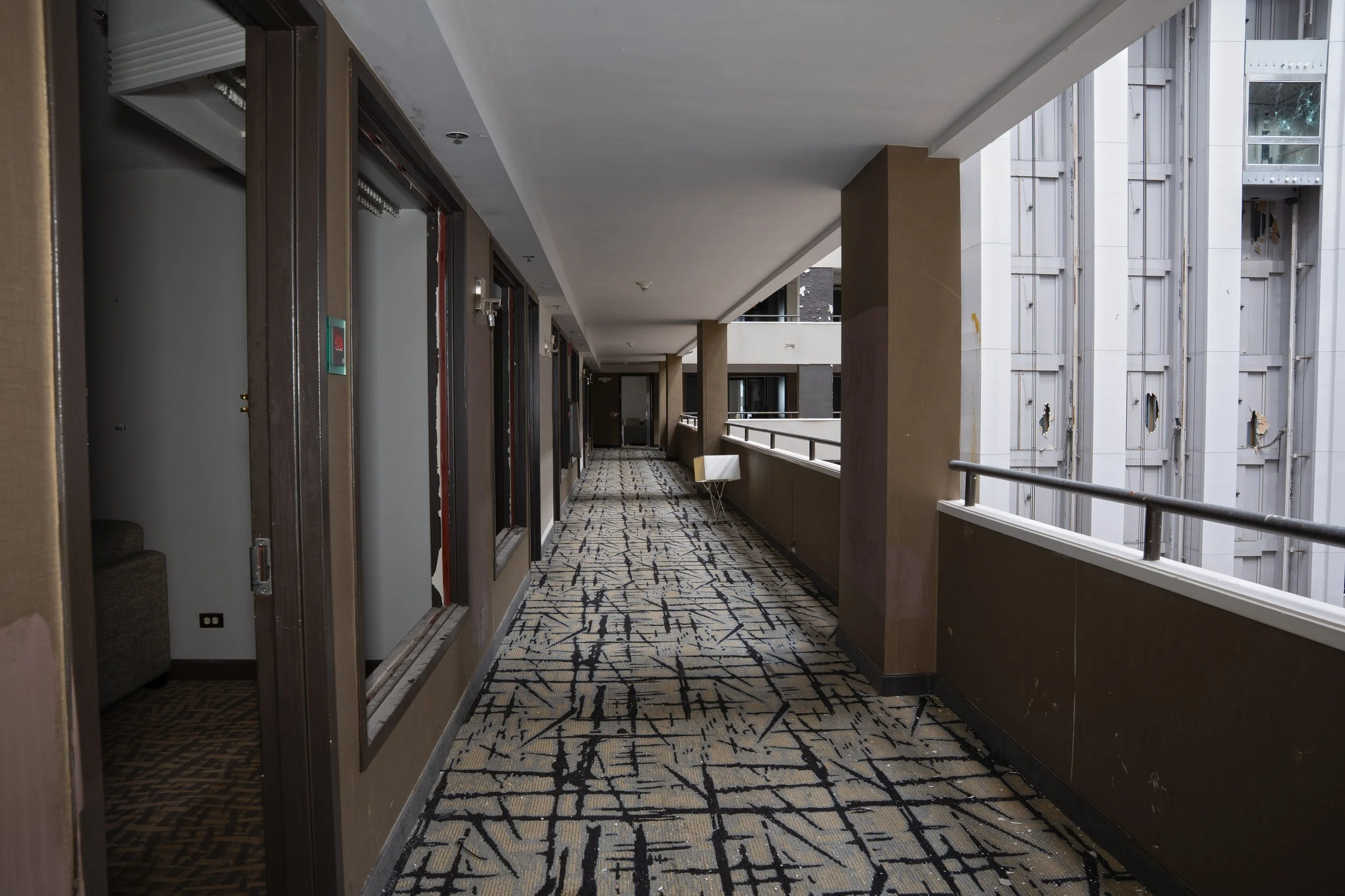 5th floor hallway with atrium on right