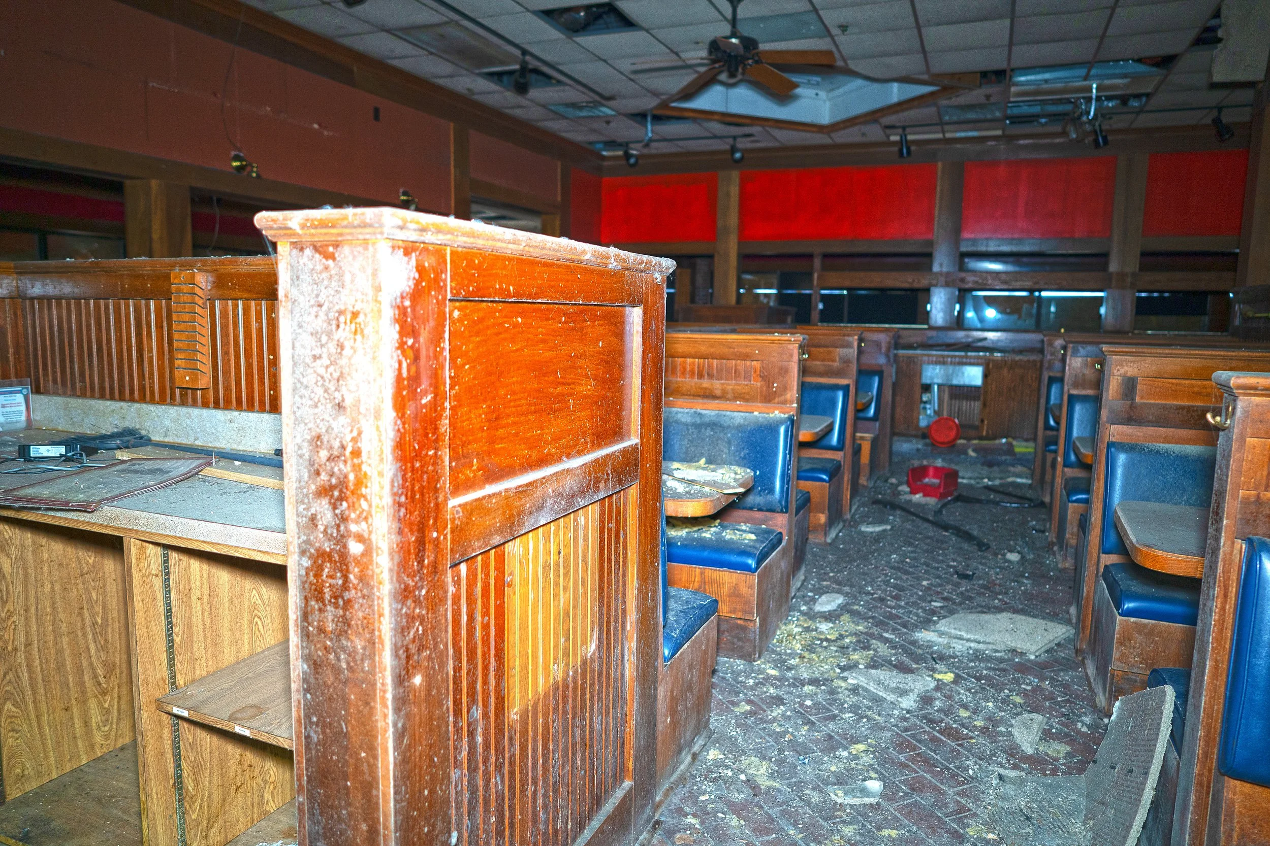 The middle aisle of the restaurant with a employee desk