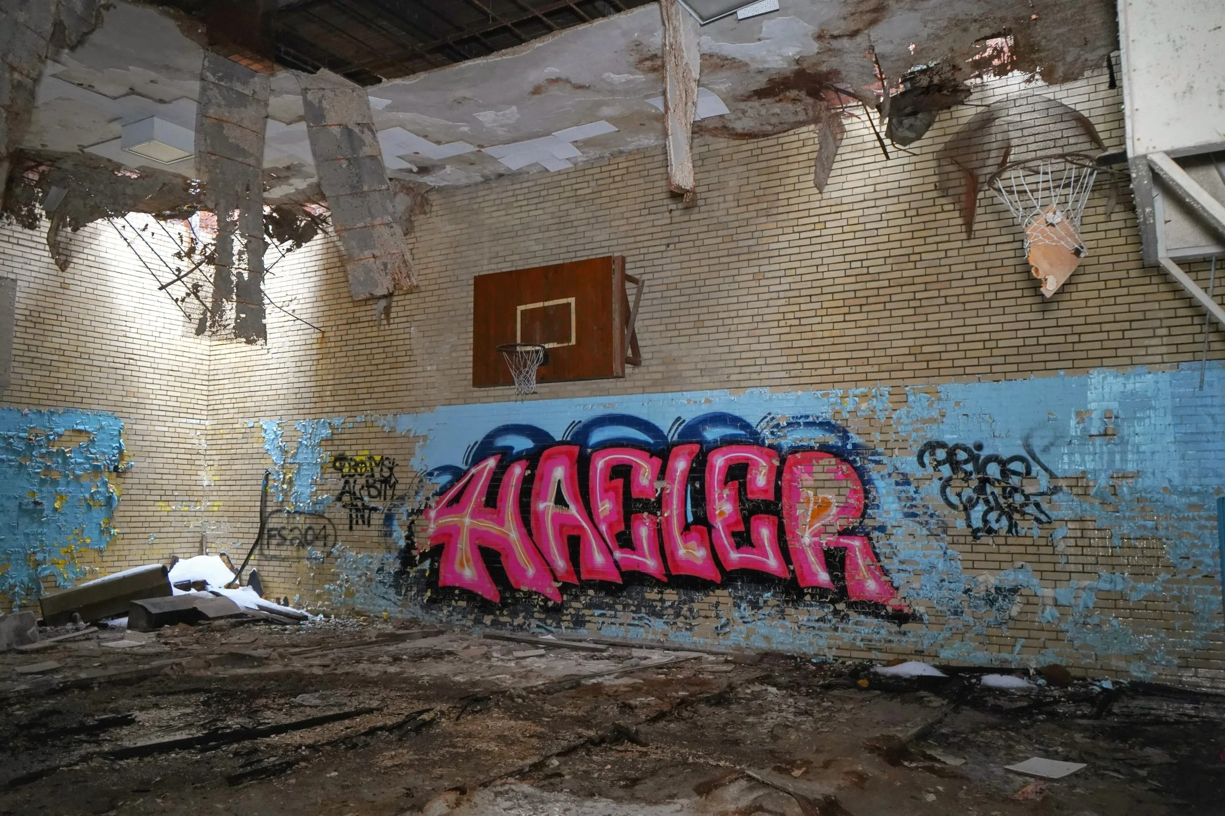 The gymnasium a unique scene with holes in the ceiling in one corner  