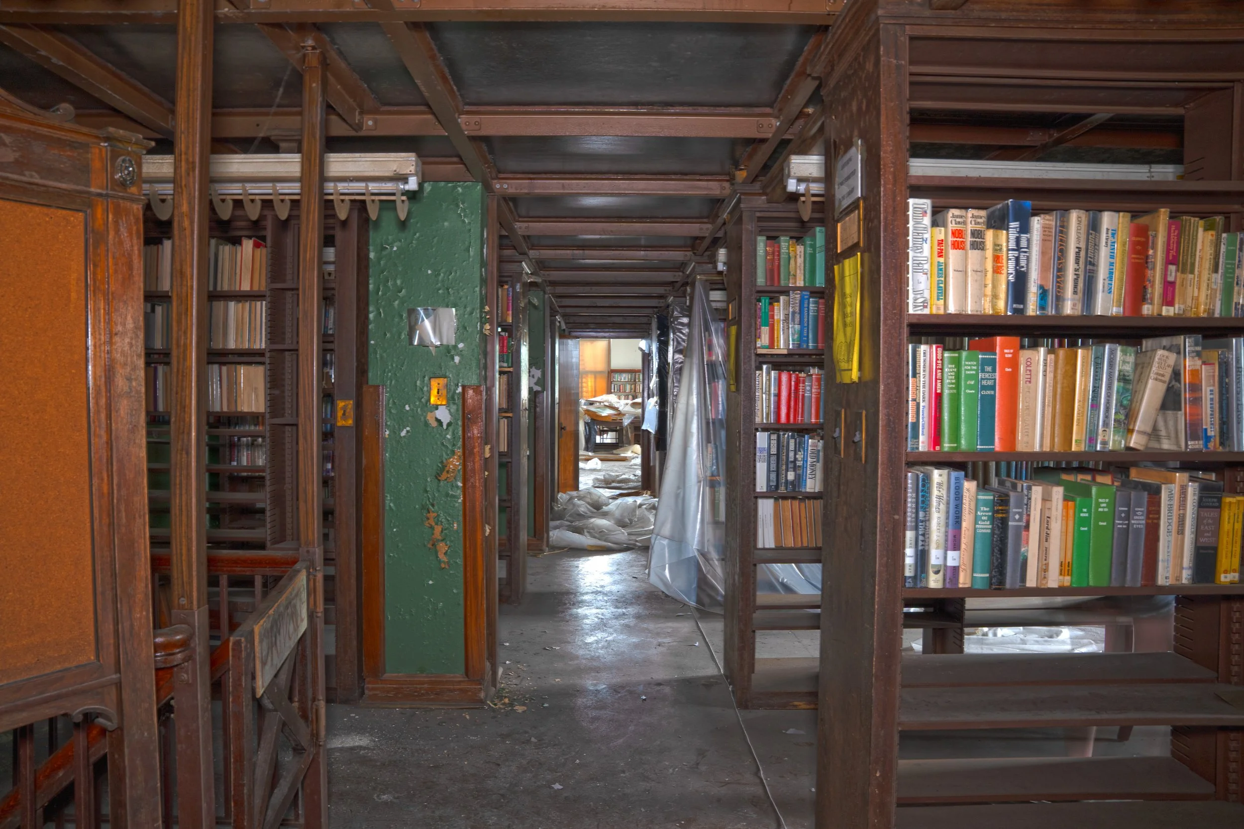 Book Storage behind main desk on 1st floor, the gate to the left leads to the basement media archive section