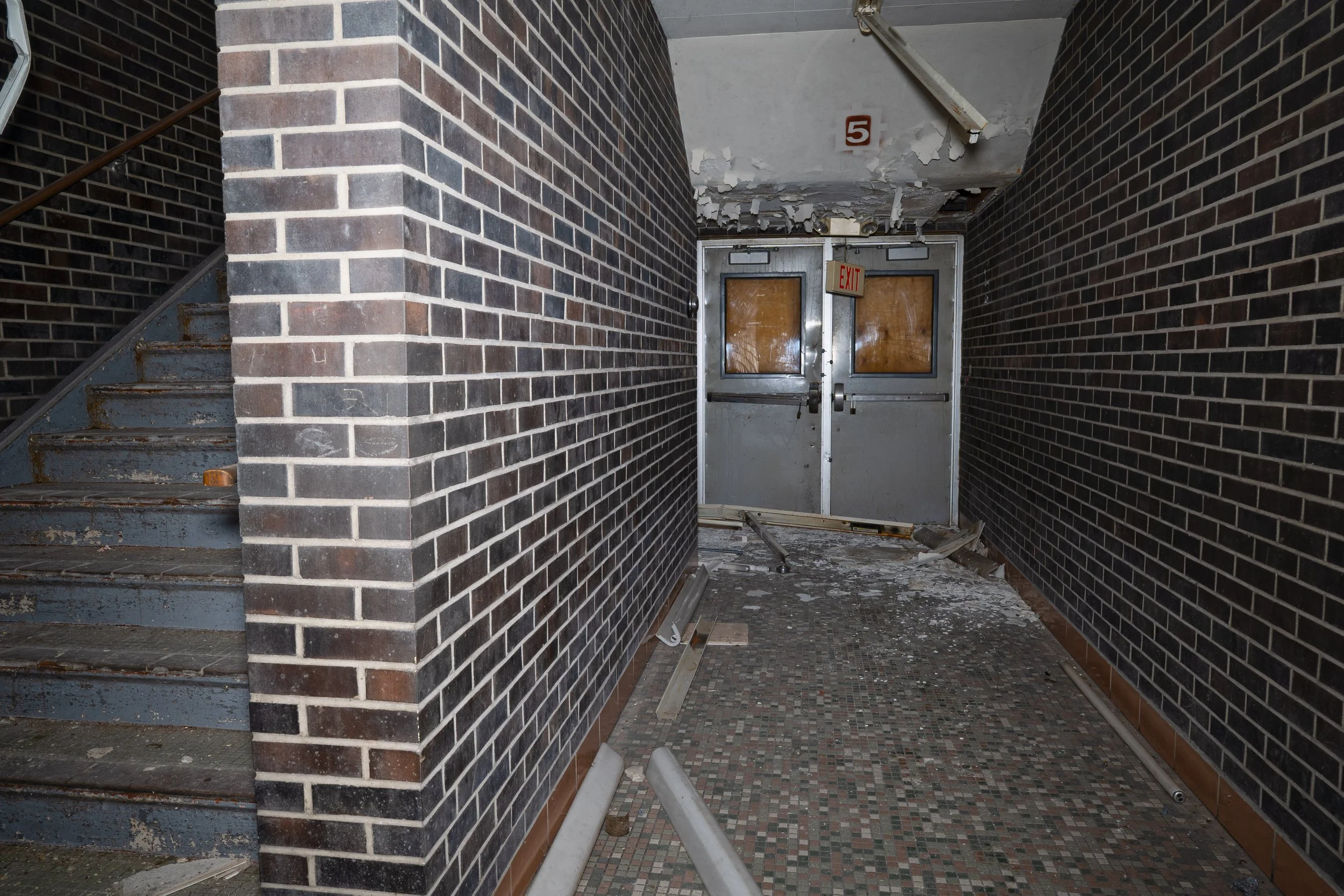 Staircase in double stacked corridor leading to 2nd floor and entrance 5 