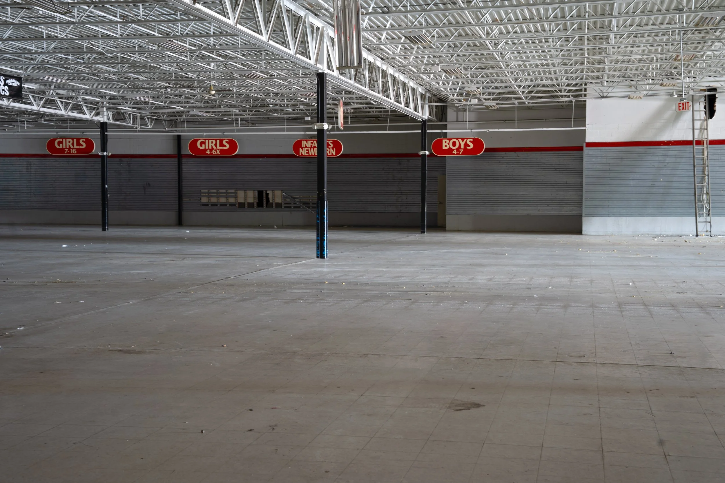 While gutted below, the signs hang above 