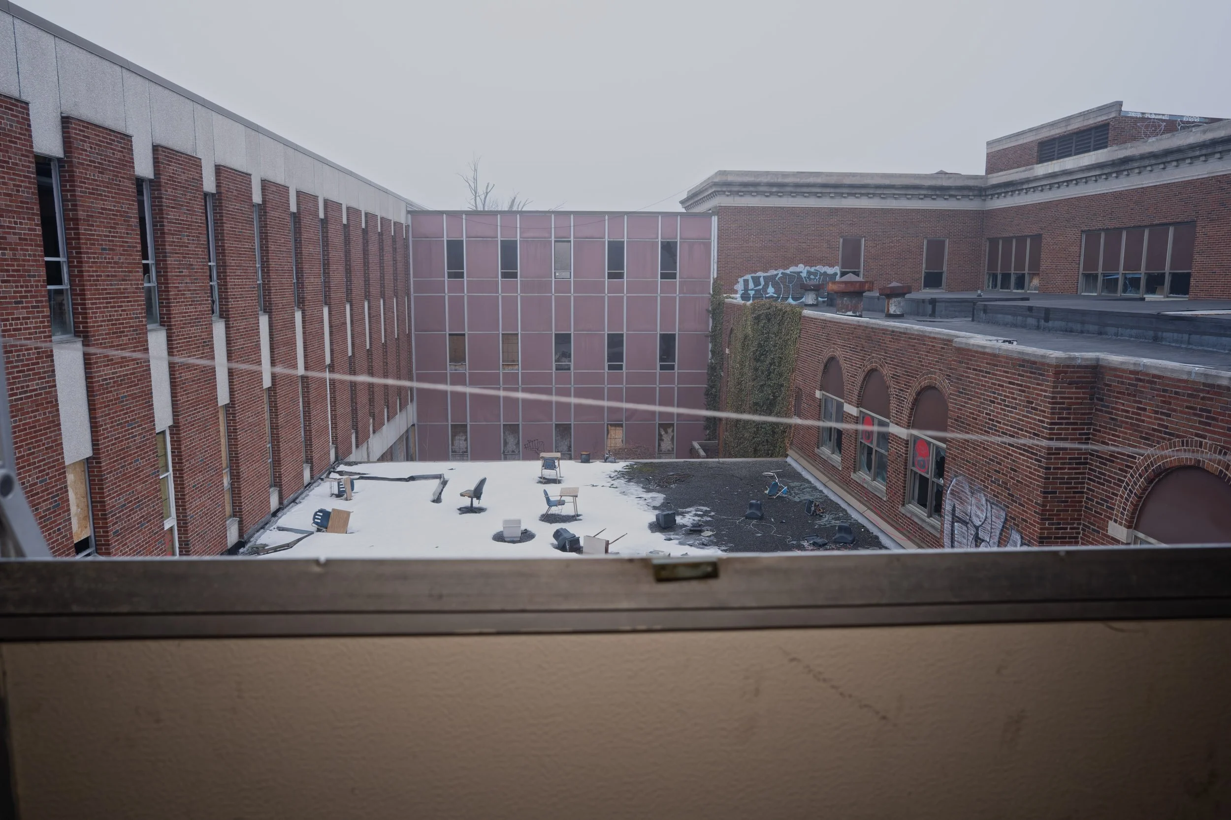 From the 2nd floor windows you can see the interior courtyard to the right you can see the gymnasium arched windows surrounded by classrooms throughout