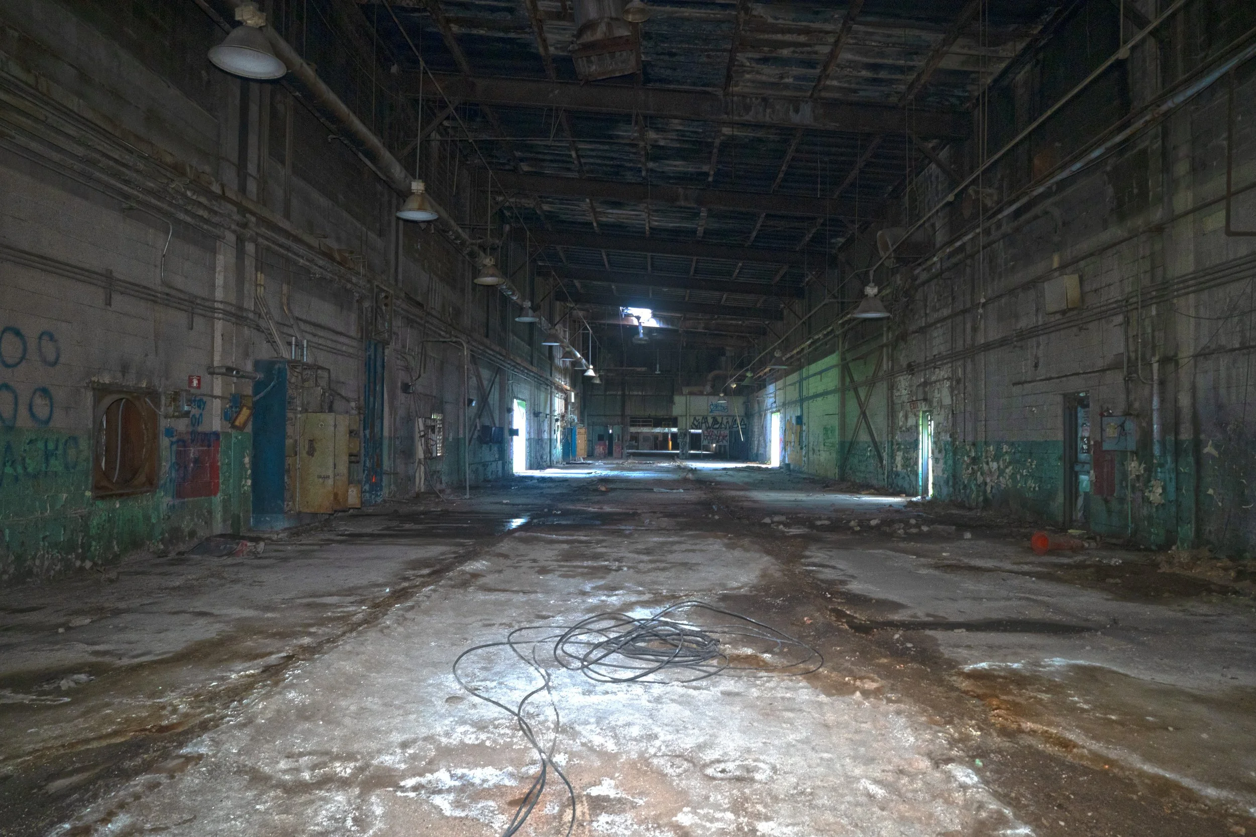A large portion of the plant is a long hallway that leads into a warehouse like space