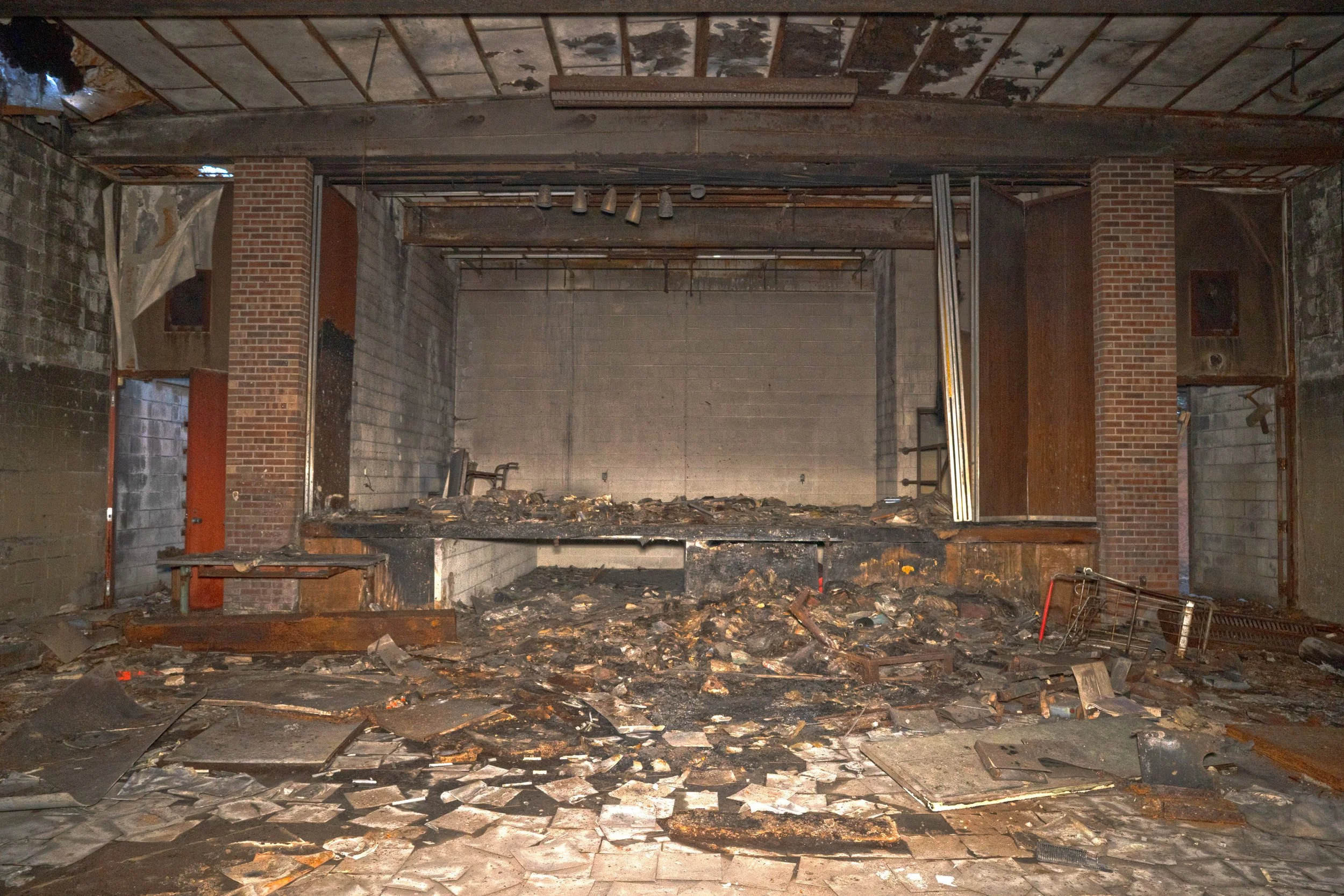 Auditorium stage in far disrepair in the basement  