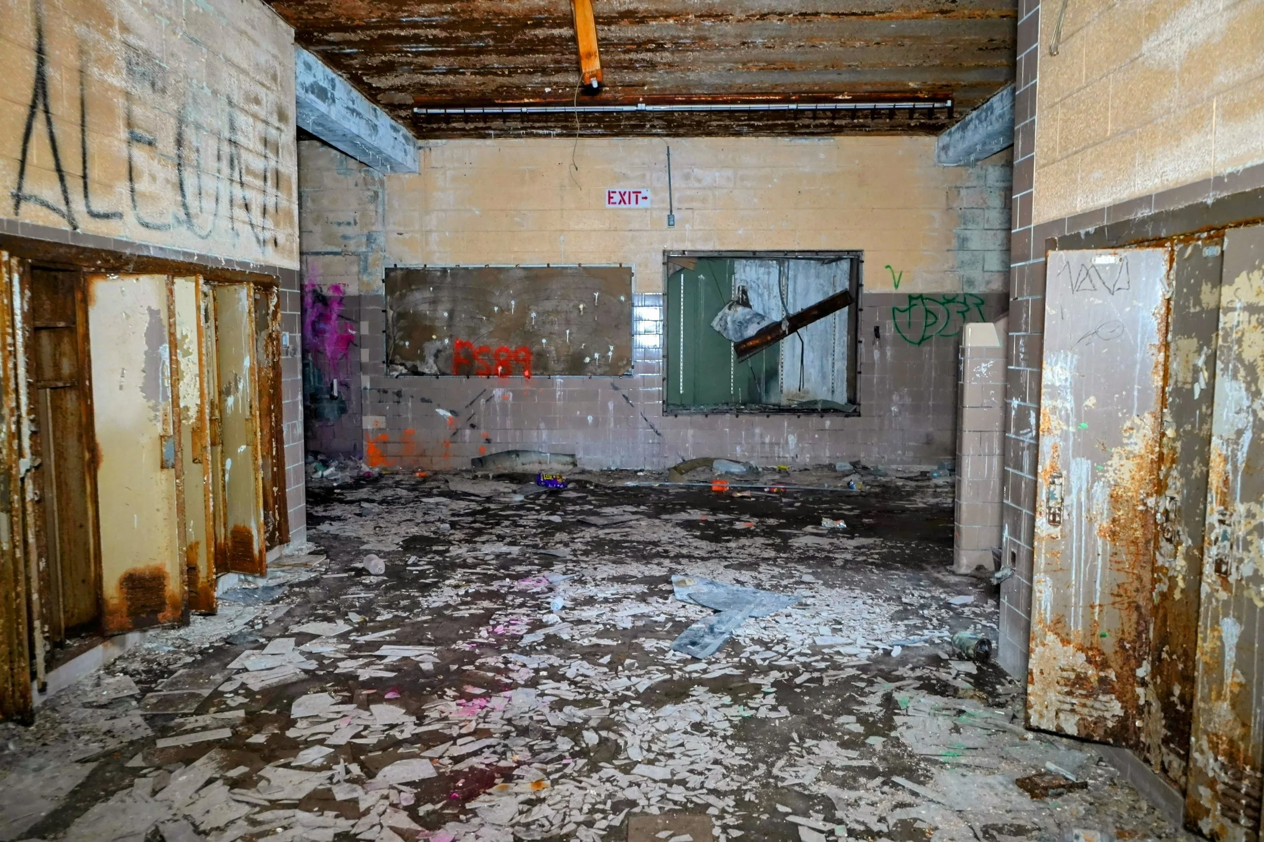 Many hallways like that of this one on the 2nd floor have had most tiles destroyed beyond repair which make a crunch sound upon walking on them