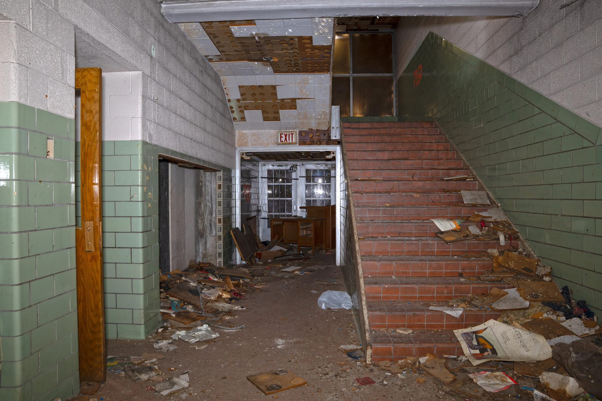 One of the secondary entrances next to a staircase leading to the 2nd floor