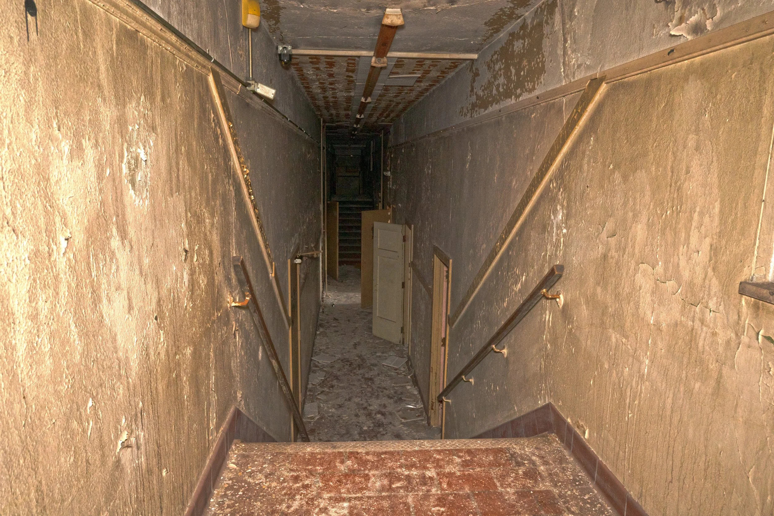 A strange corridor in the school with a up and down stair design 