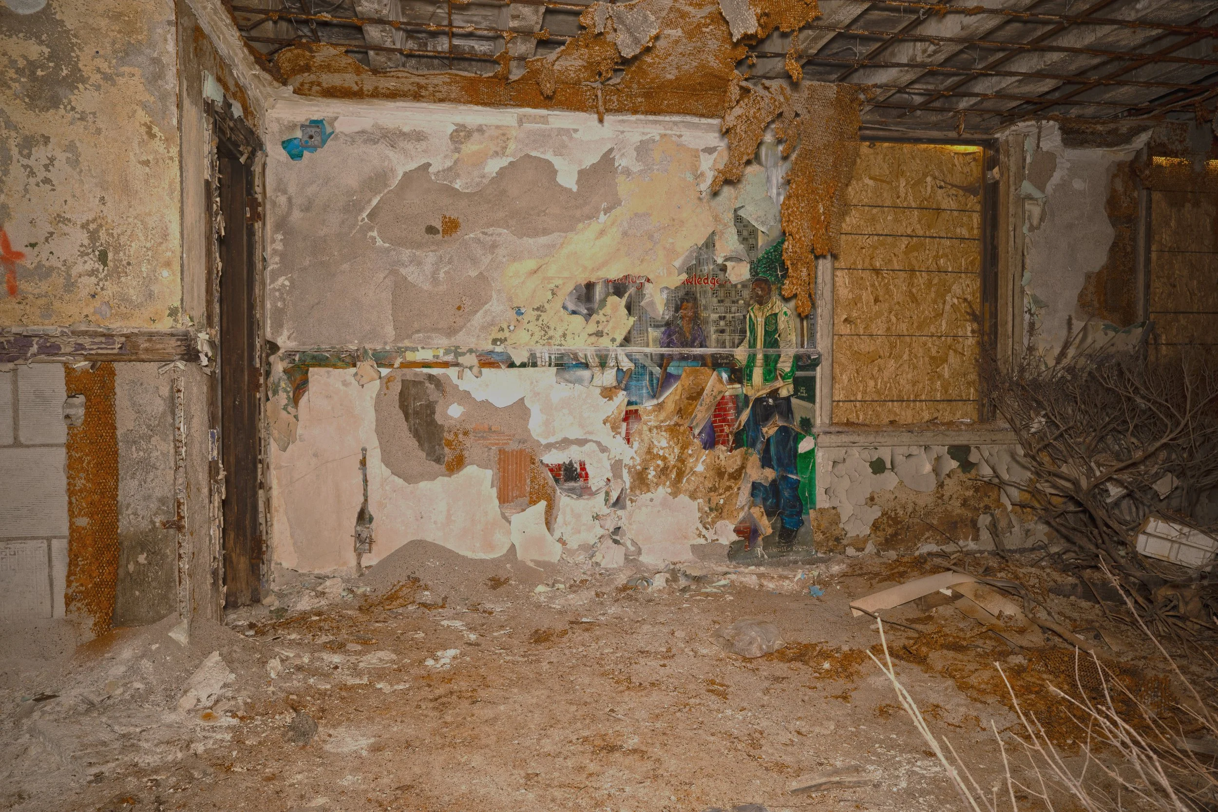 A very decayed mural outside the back auditorium entrance 