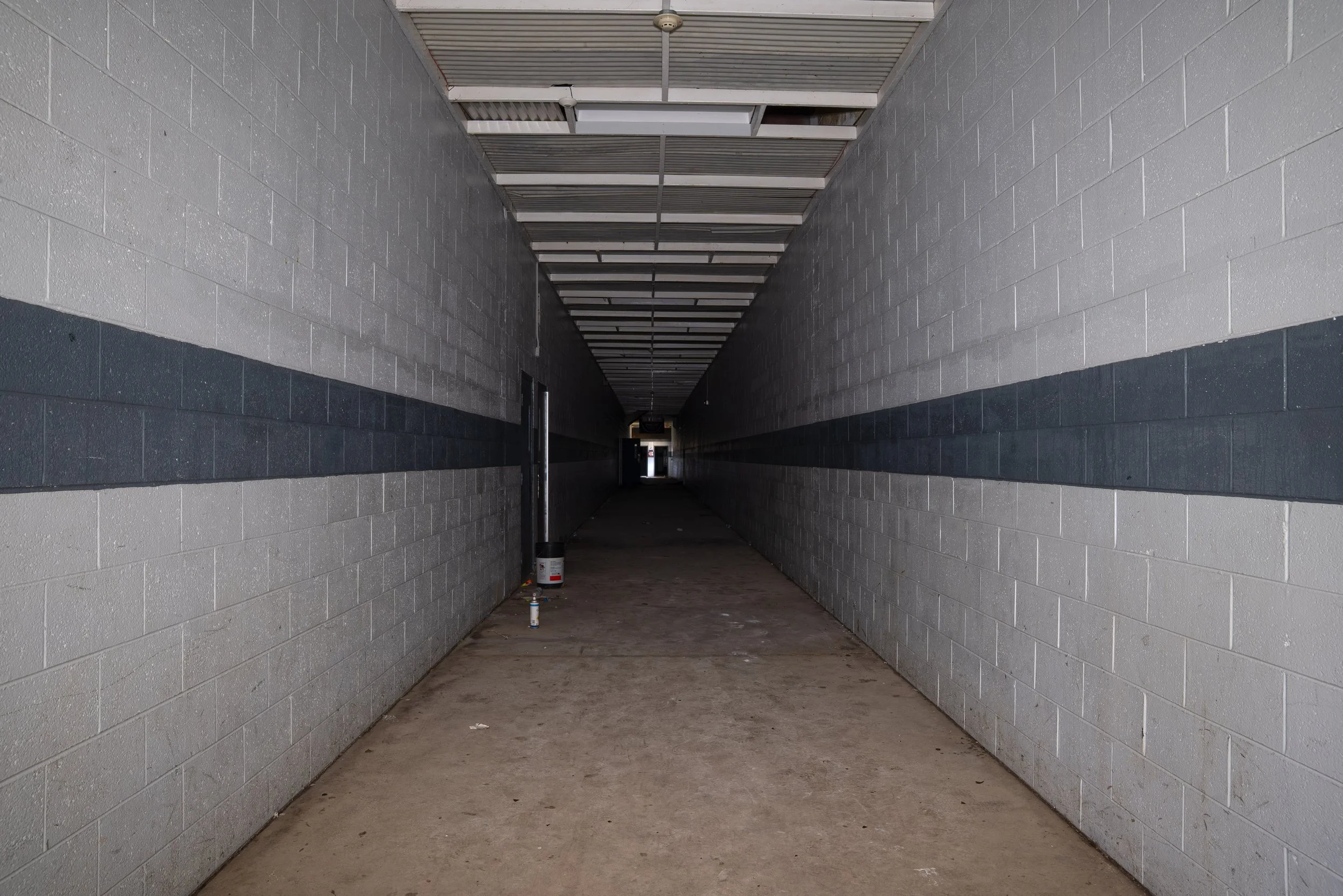 Main hallway leading to the back of the building straight down the hallway is the remaining hockey rink, on the left is the sandy converted rink and on the right is the basketball court