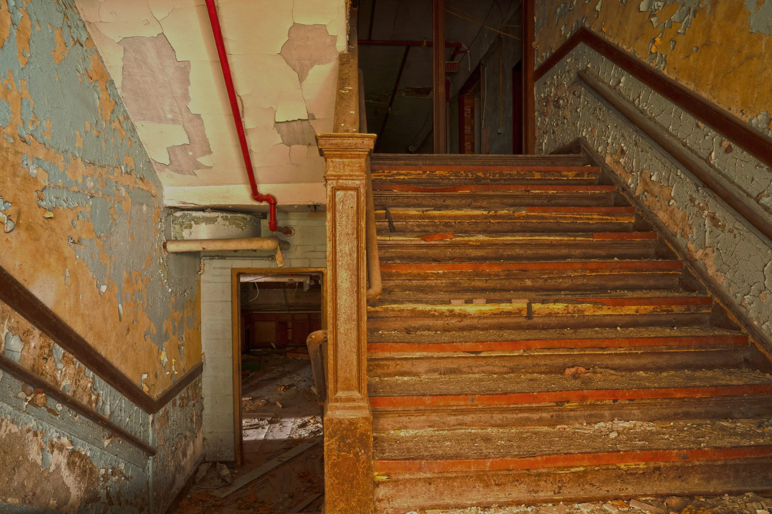 1st floor staircase connecting the basement, 1961 addition and the 1905 build together natural light from the 1961 addition windows adds to the picture 