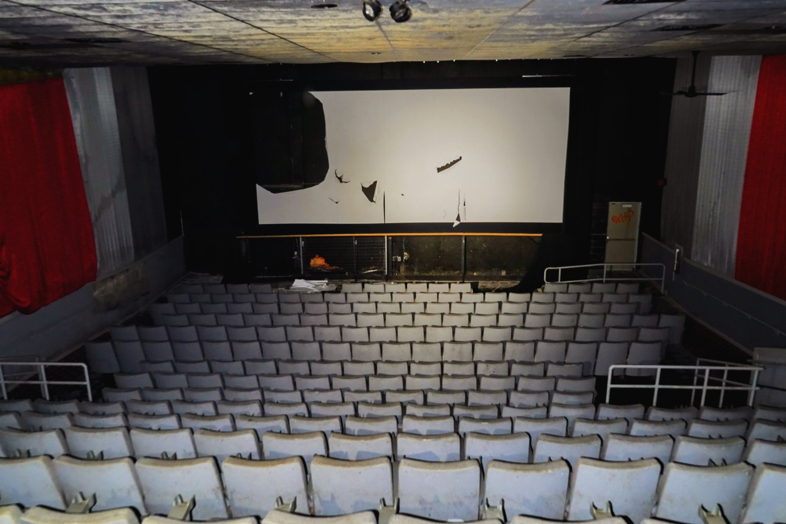 Abandoned movie theater with torn screen