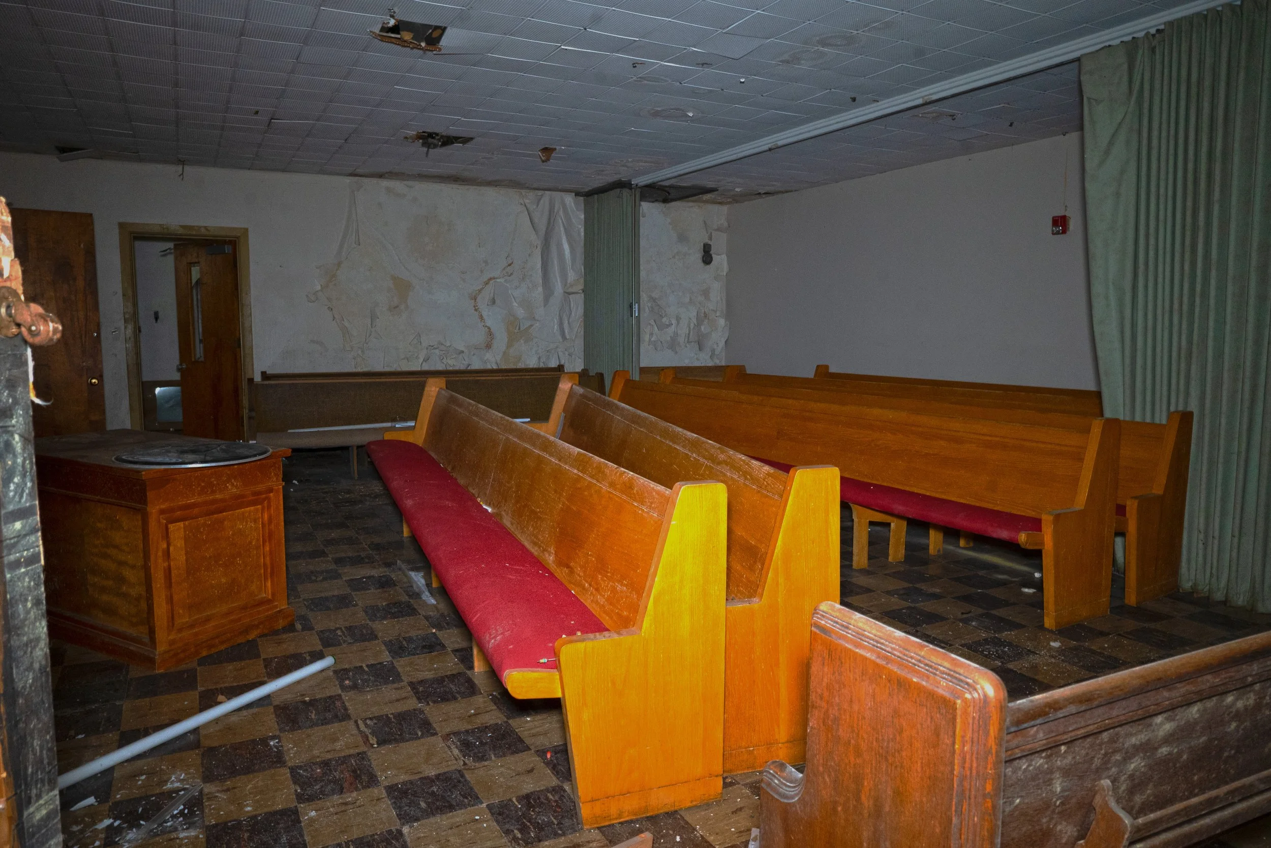Church pews in storage in a room nearby to the main church room