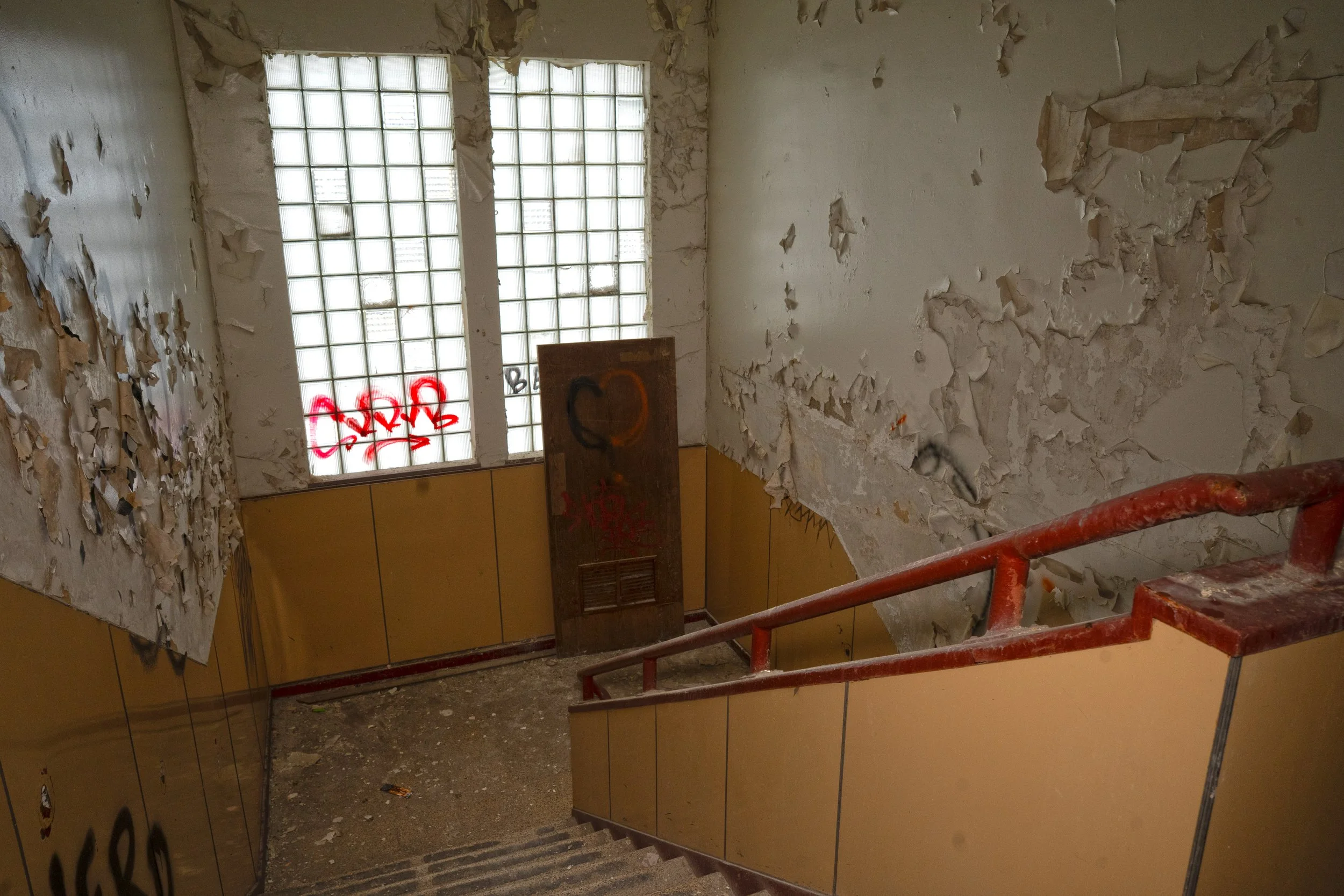 that same stairwell as seen from the 3rd floor glass block windows of the 1950s era build remain intact