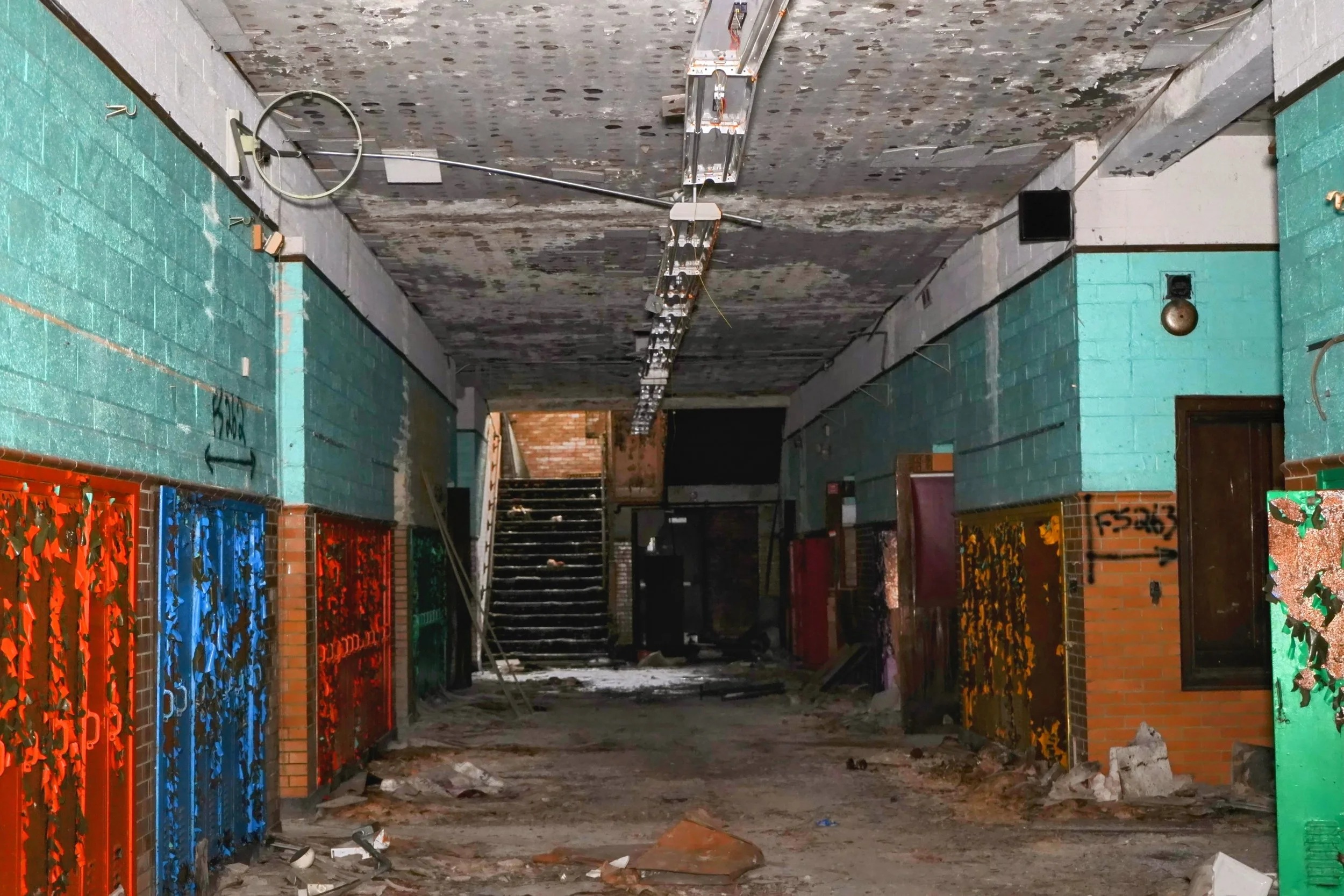 A clock fixture remains in place commonly found in abandoned Detroit Public Schools