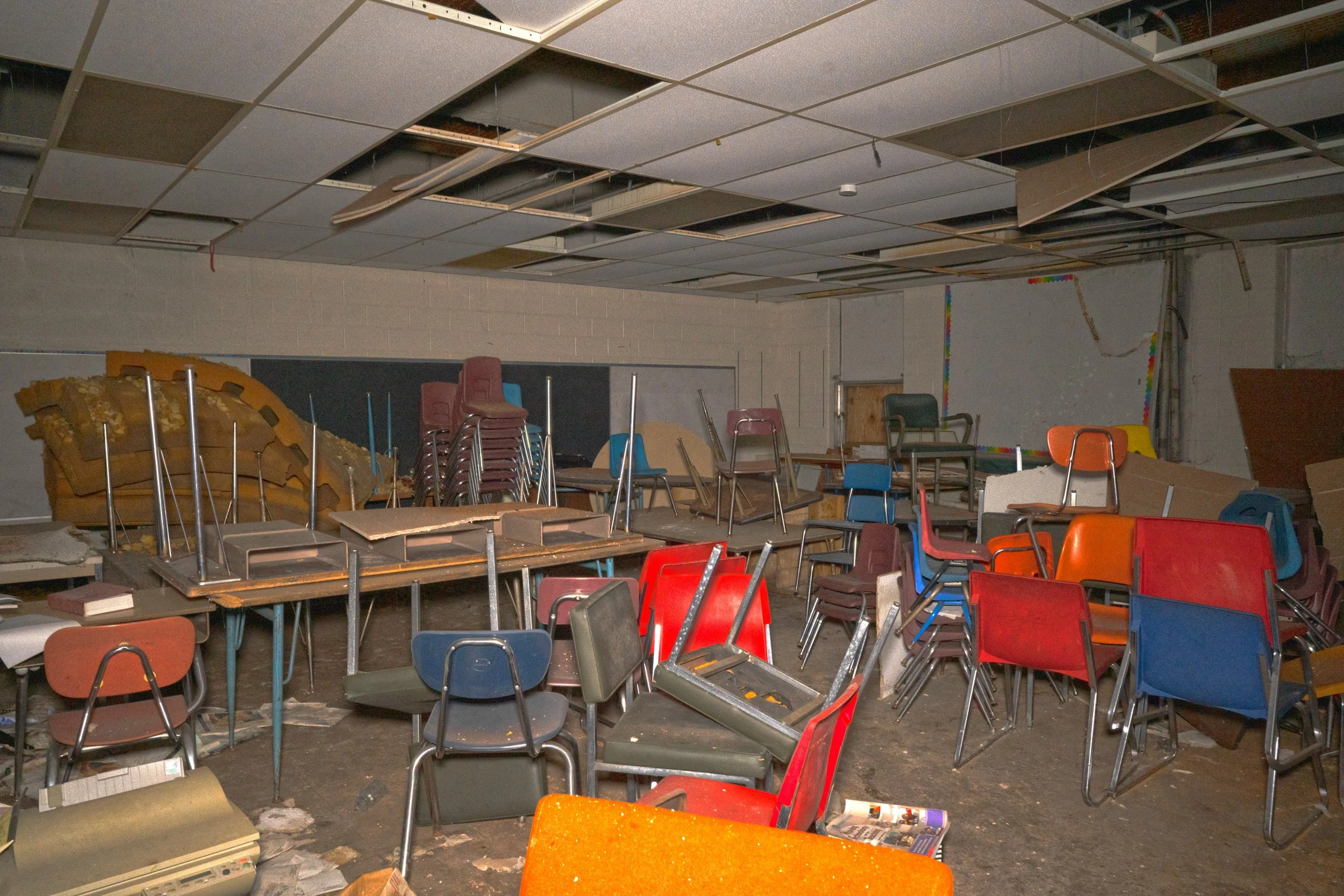 Another 1st floor classroom with desk and chairs intact, the room in general is intact