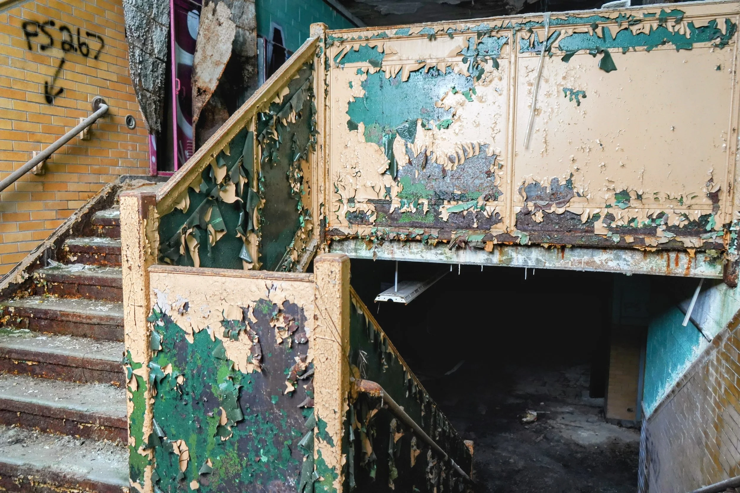 Green paint lines a probably once beautiful staircase  
