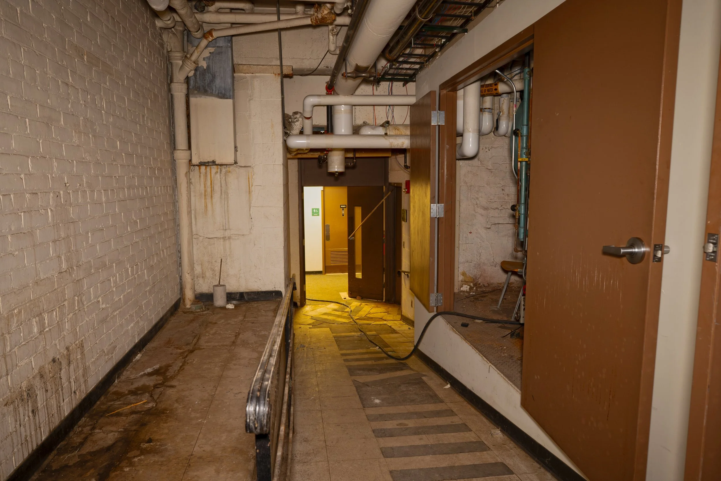 Ramp leading down from mechanical spaces and addition research sections in the basement section to the basement corridor below  