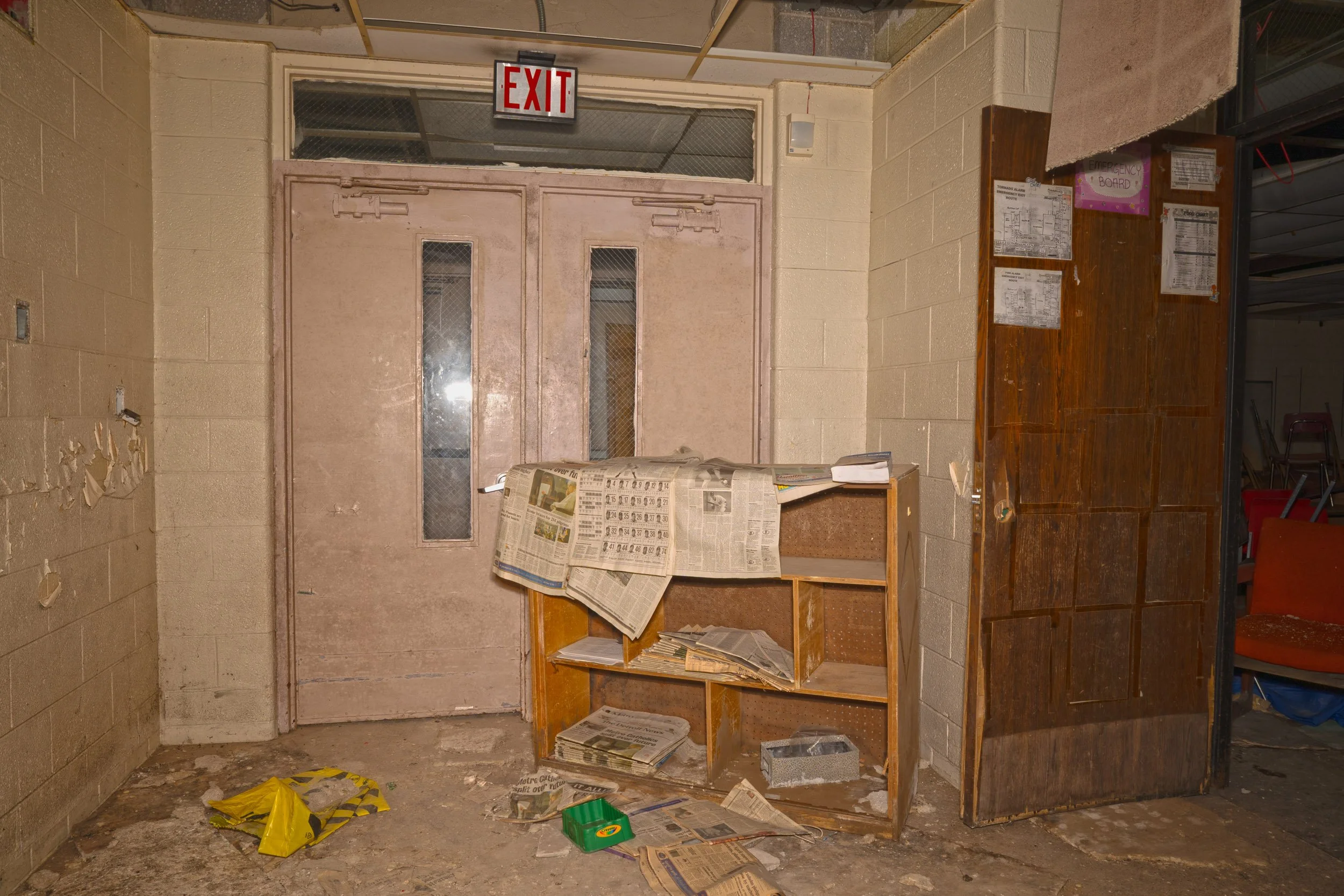 In a corner of liberty a shelf of newspapers is present in near perfect shape