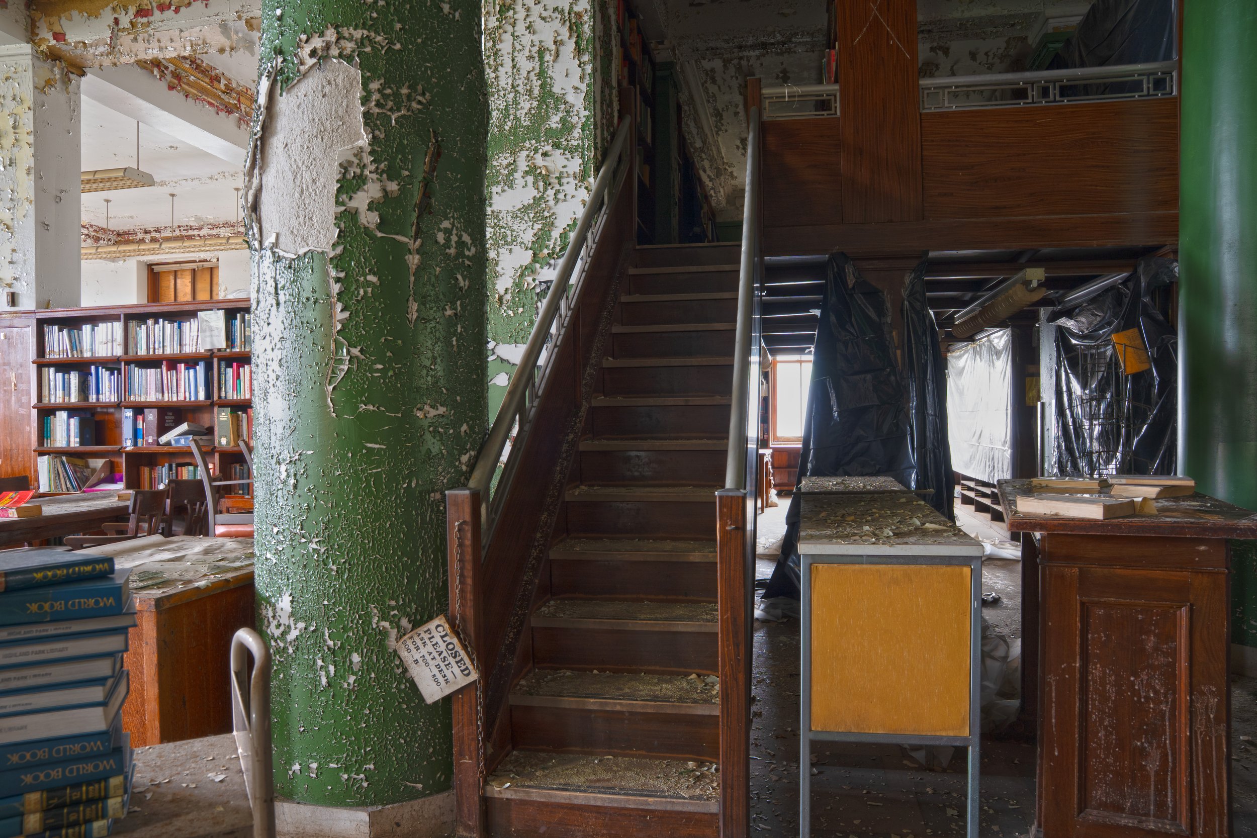 Stairs leading to additional books above and behind the desk between the 1st and 2nd floors