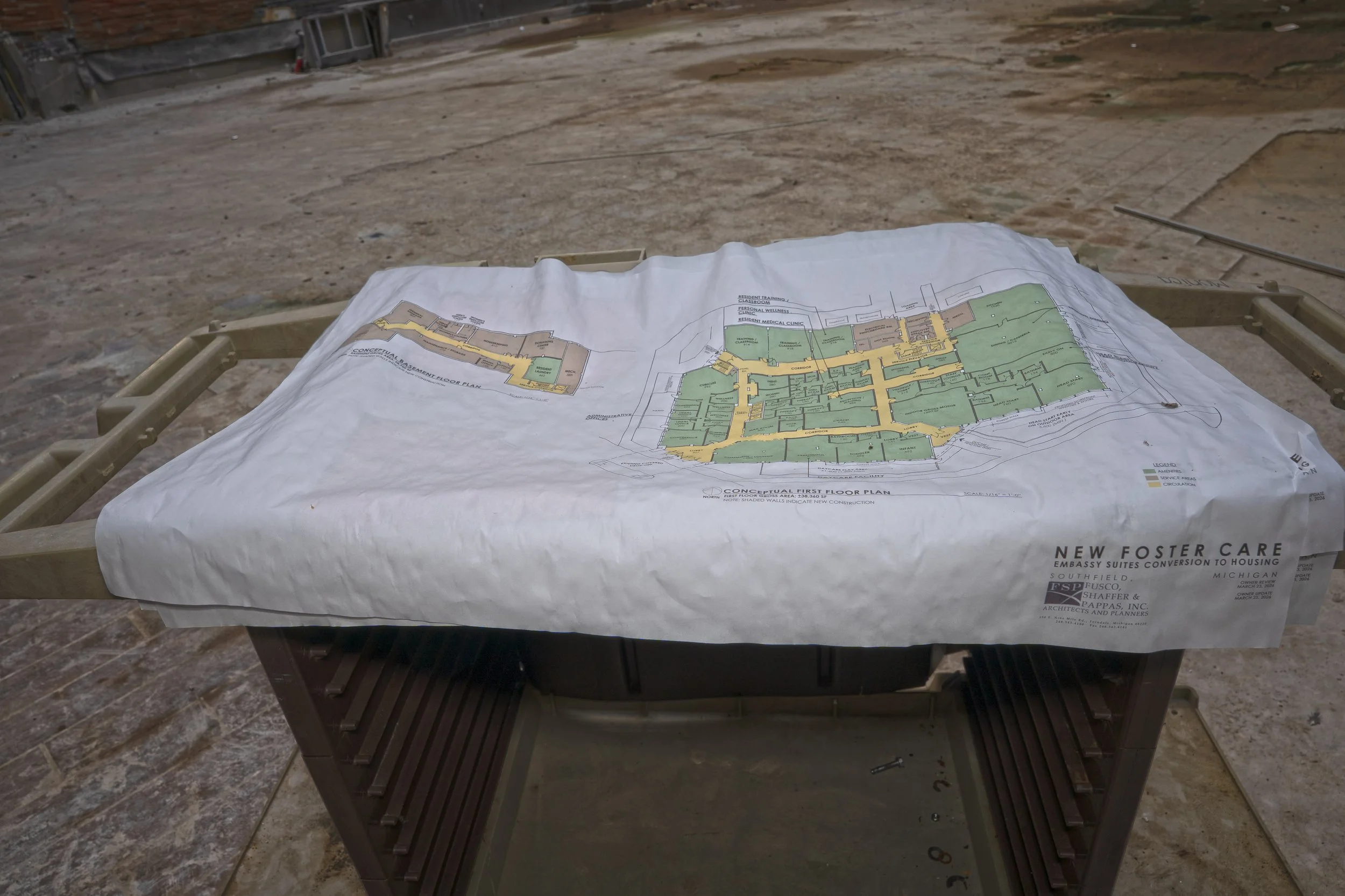 plans on a makeshift table on the 1st floor in the atrium show renovation plans 