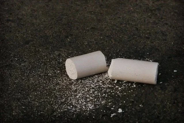 White broken chalk on a black background