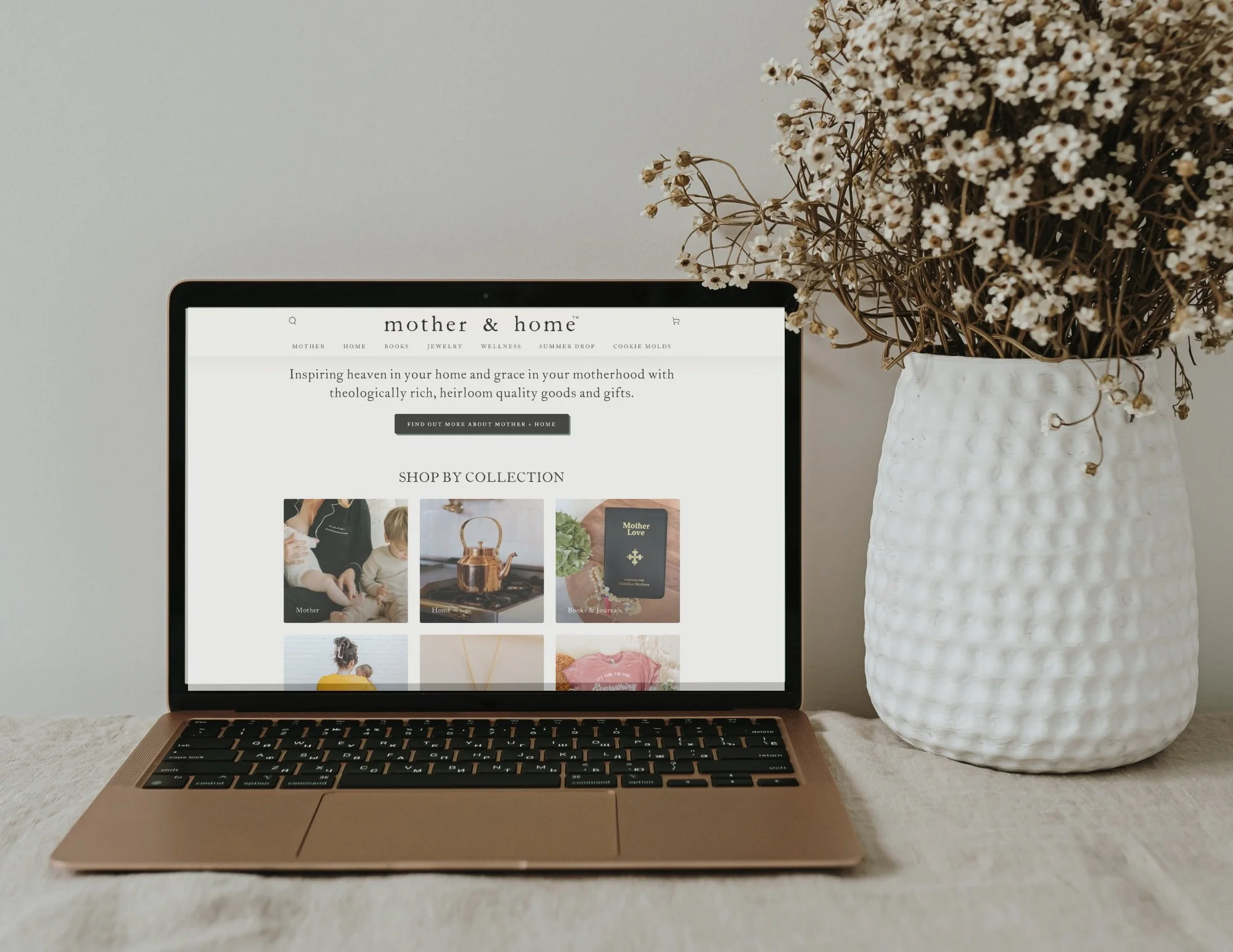 A laptop mock up with the mother and home market home page design