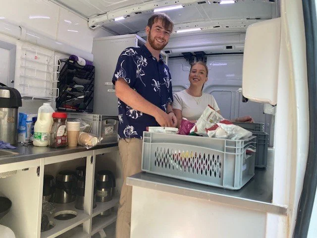 Two Charles White employees on the Bethany Care Van preparing food to hand out in central Edinburgh.