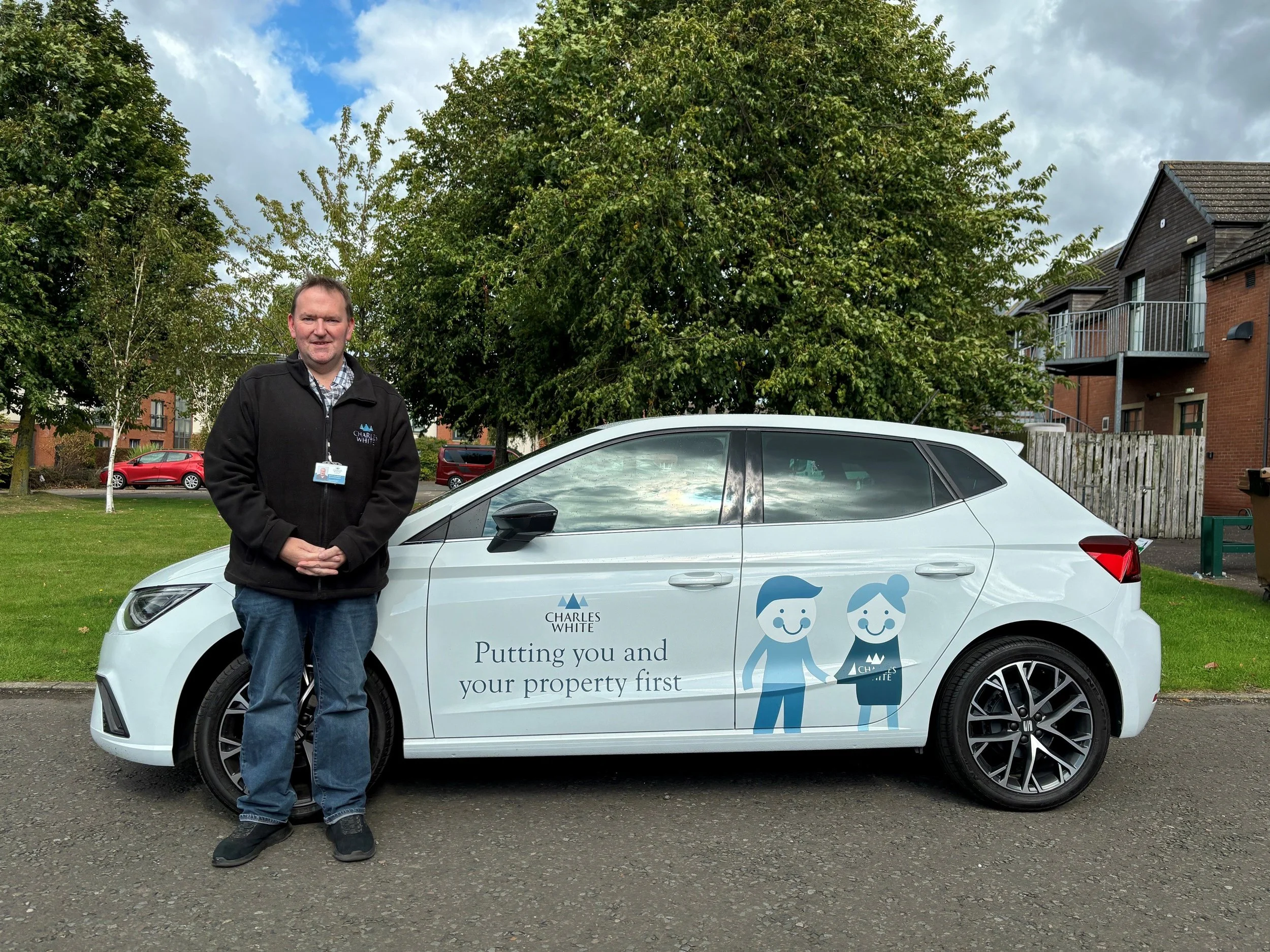 Development Inspector in from of a Charles White car