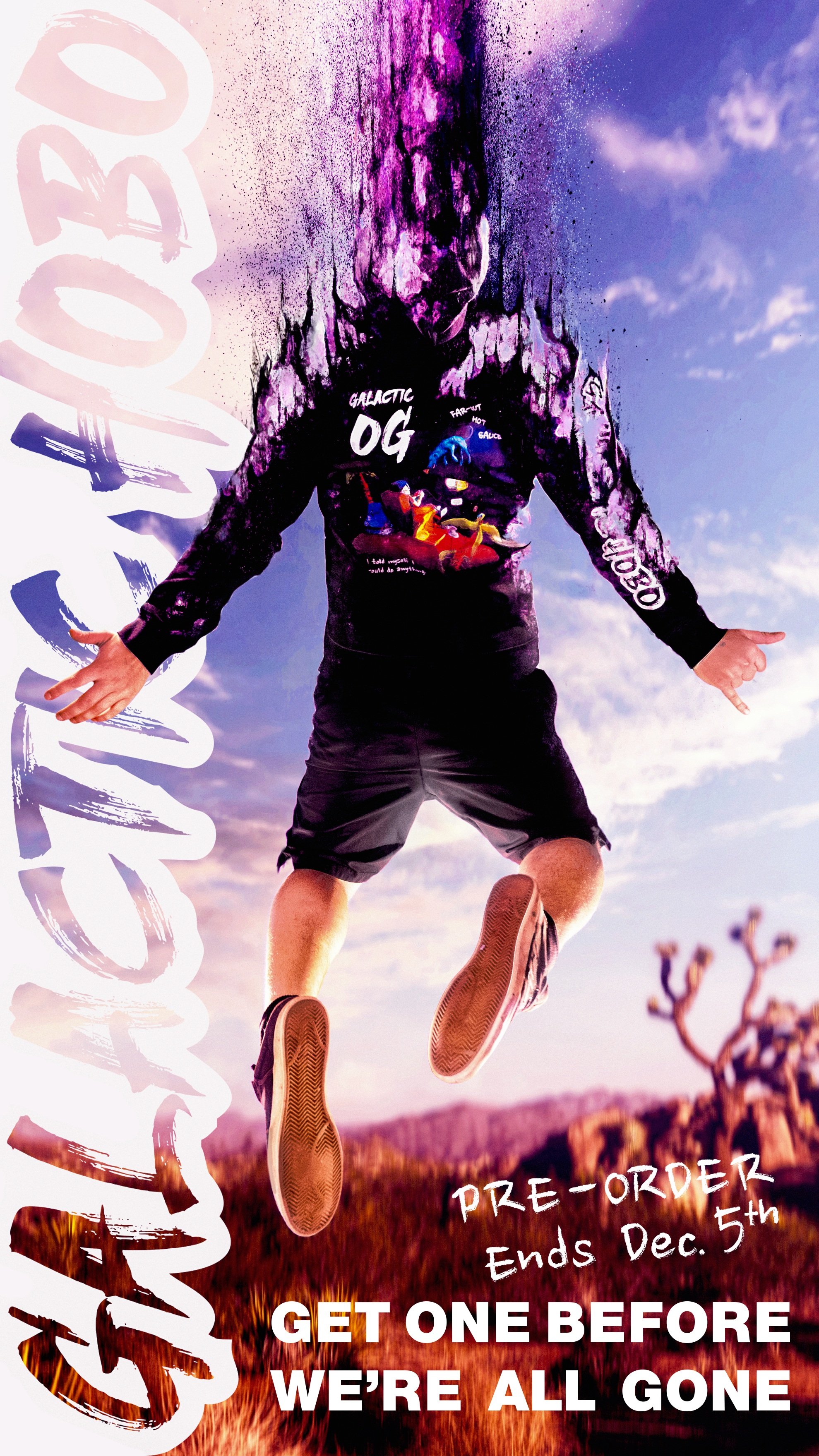 A person jumping in the air, wearing a black jacket with colorful graphics and shorts, with a desert landscape and mountain in the background, under a partly cloudy sky.