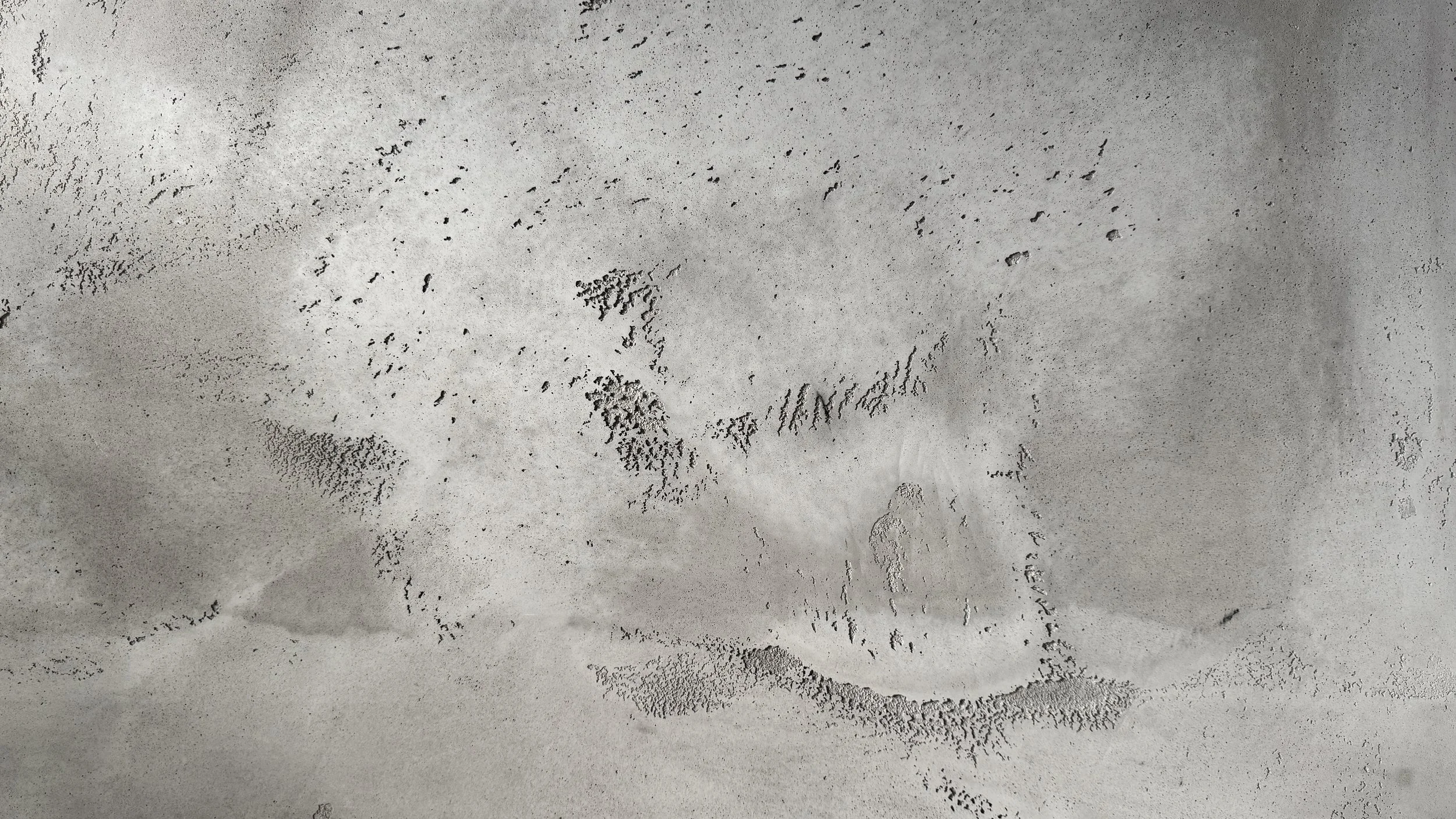 Footprints in the sand on a beach.