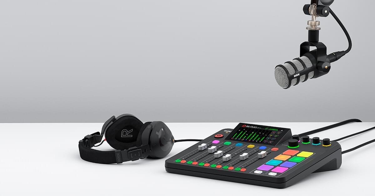 A man in a black Nike shirt and black cap recording vocals in a professional studio with a Rode microphone and pop filter.