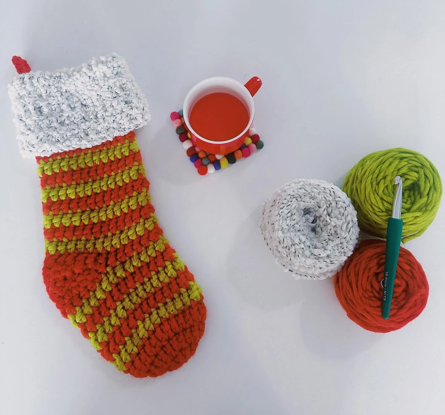 The art and the artist! It is officially Stocking Season - and we love making stockings with our new super bulky yarns 🎅   Jennifer used our Blue Sky Fibers Woolstok North for the body of this stocking, and Urth Lanalpaca for the fuzzy trim. The sup