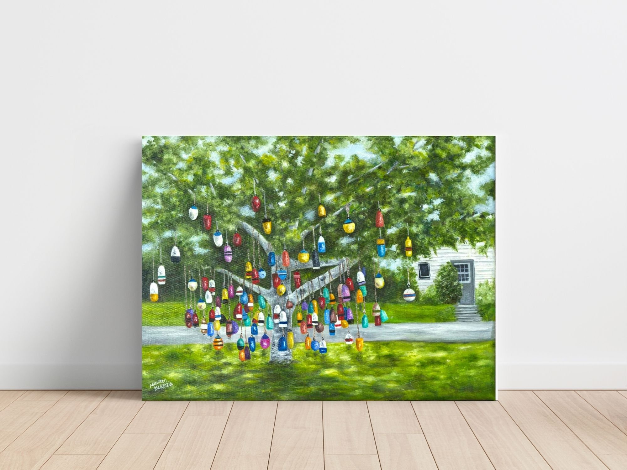 Original 12x16 oil painting of a colourful buoy tree in Prince Edward Island, featuring hanging fishing buoys beneath a leafy green tree in a coastal Maritime setting.