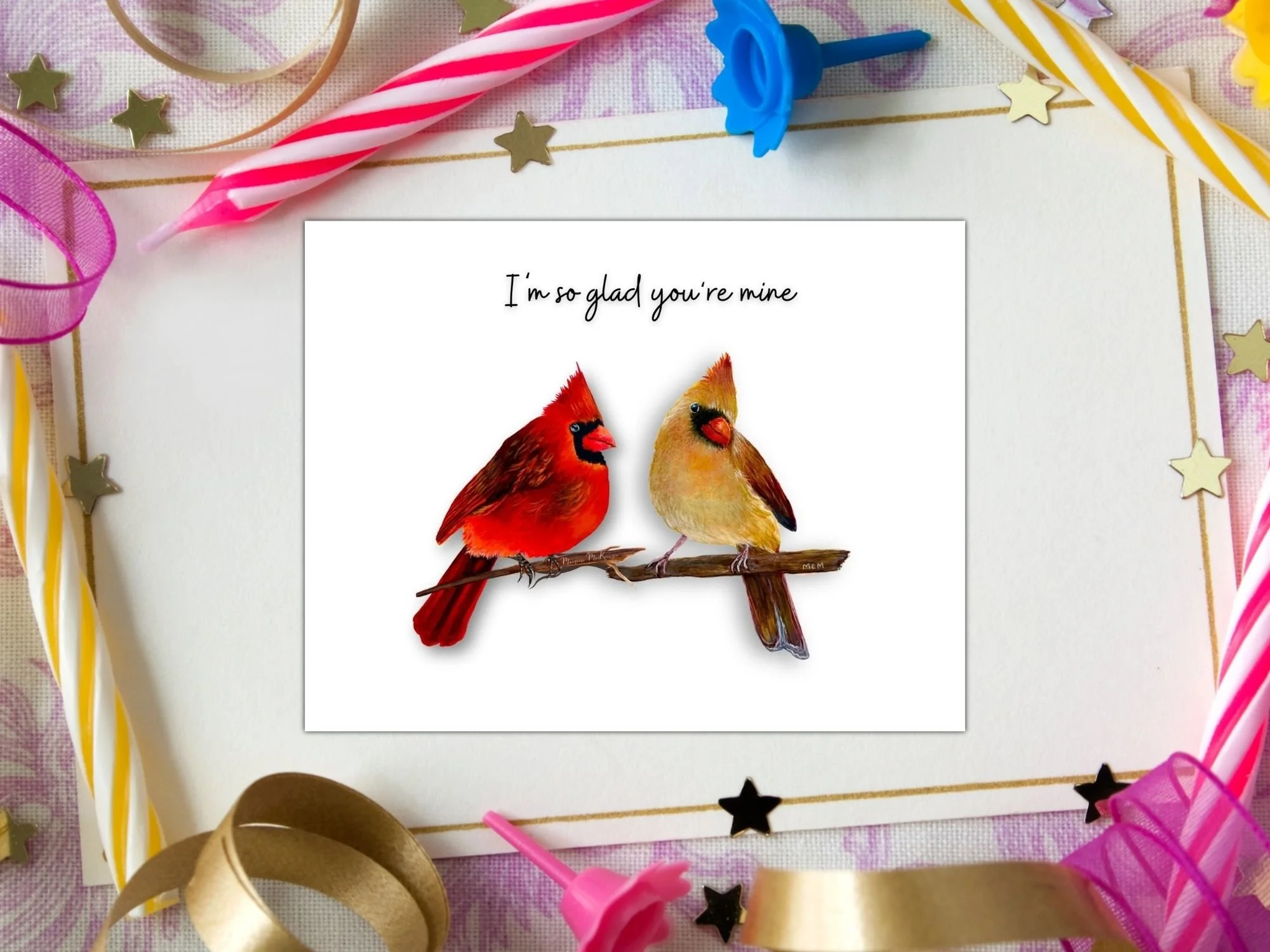 a greeting card of a male and female cardinal perched on a branch facing each other.  The greeting about them says I'm so glad you're mine
