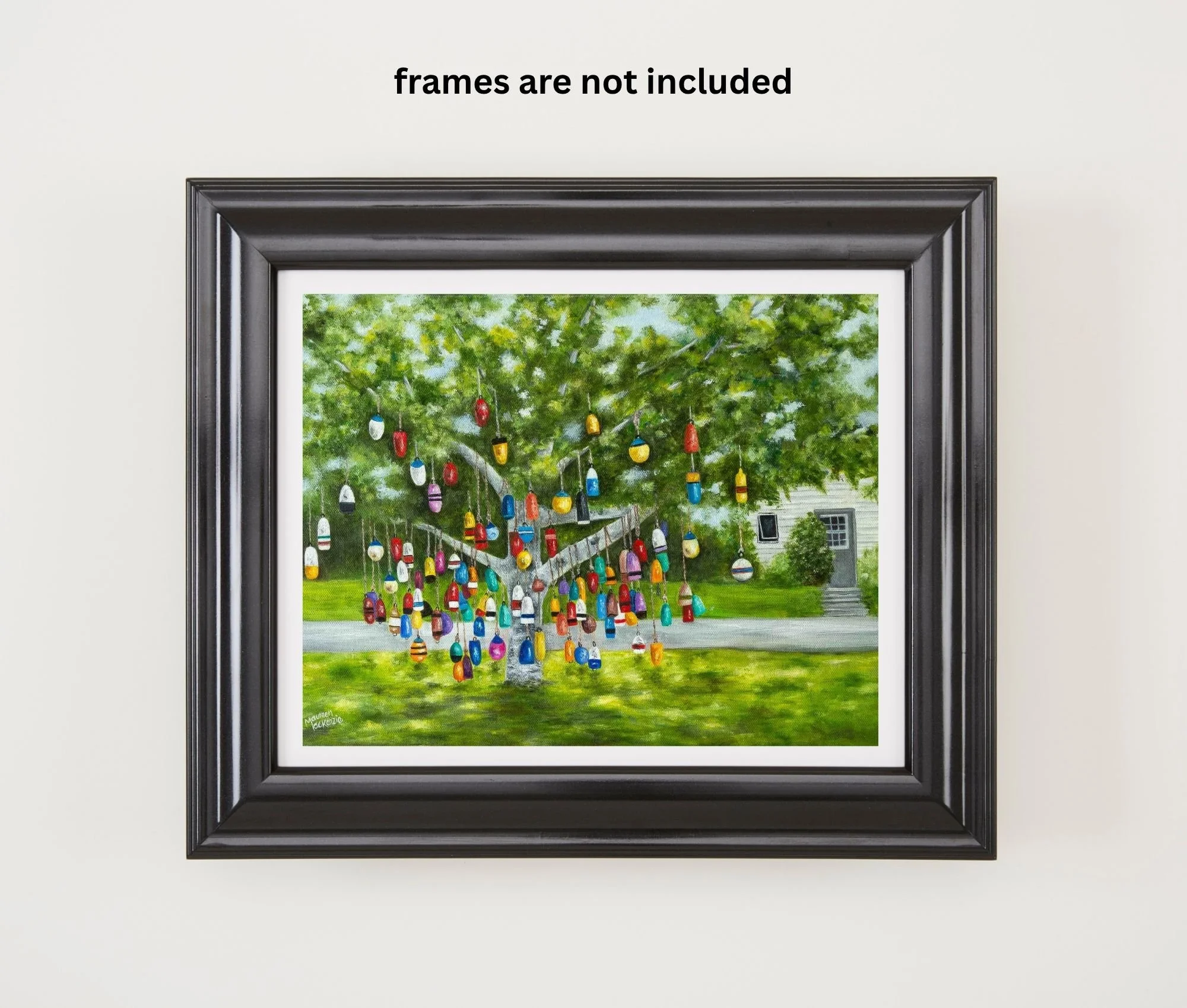A framed print of a colourful buoy tree in Prince Edward Island, reproduced from an original oil painting featuring colorful hanging fishing buoys beneath a leafy green tree.