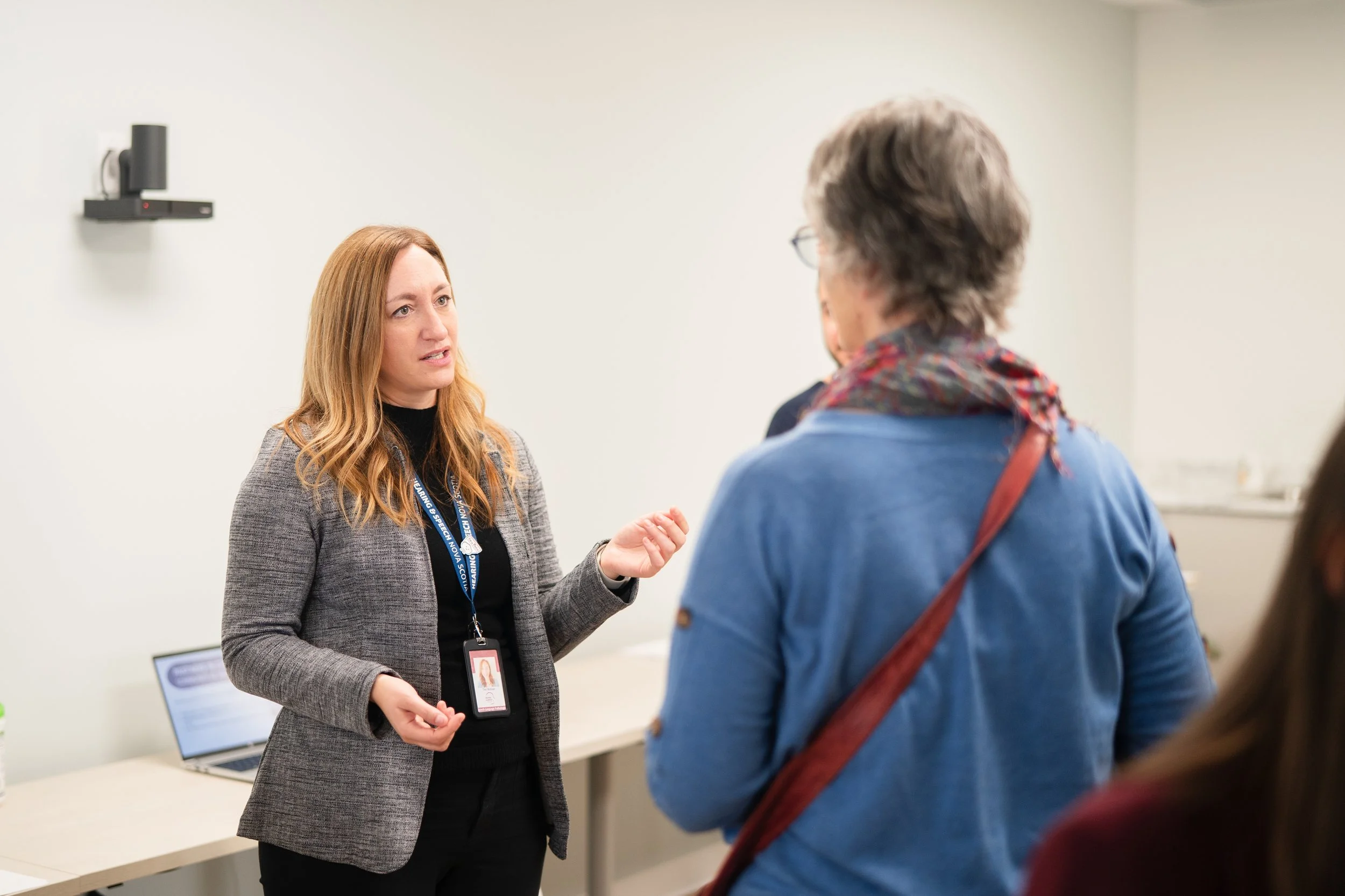 HSNS staff member speaking to person at new clinic Open House